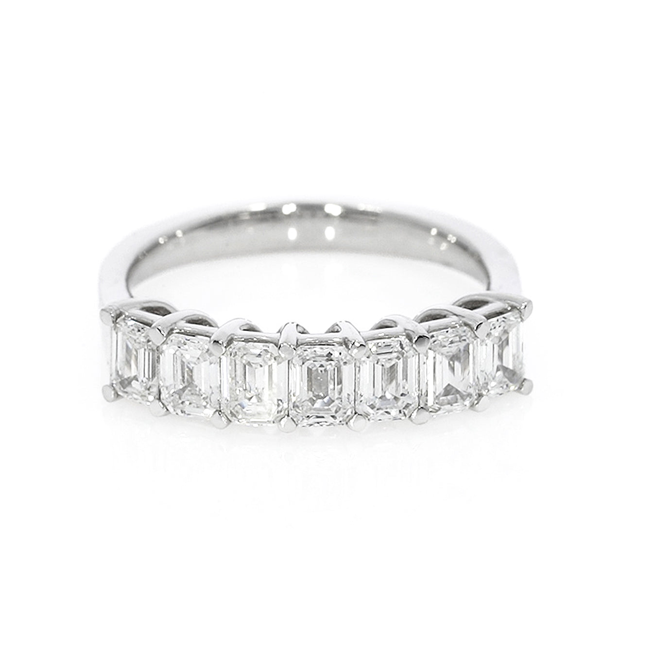 Emerald cut eternity ring featuring emerald cut diamonds set by side in a white gold band