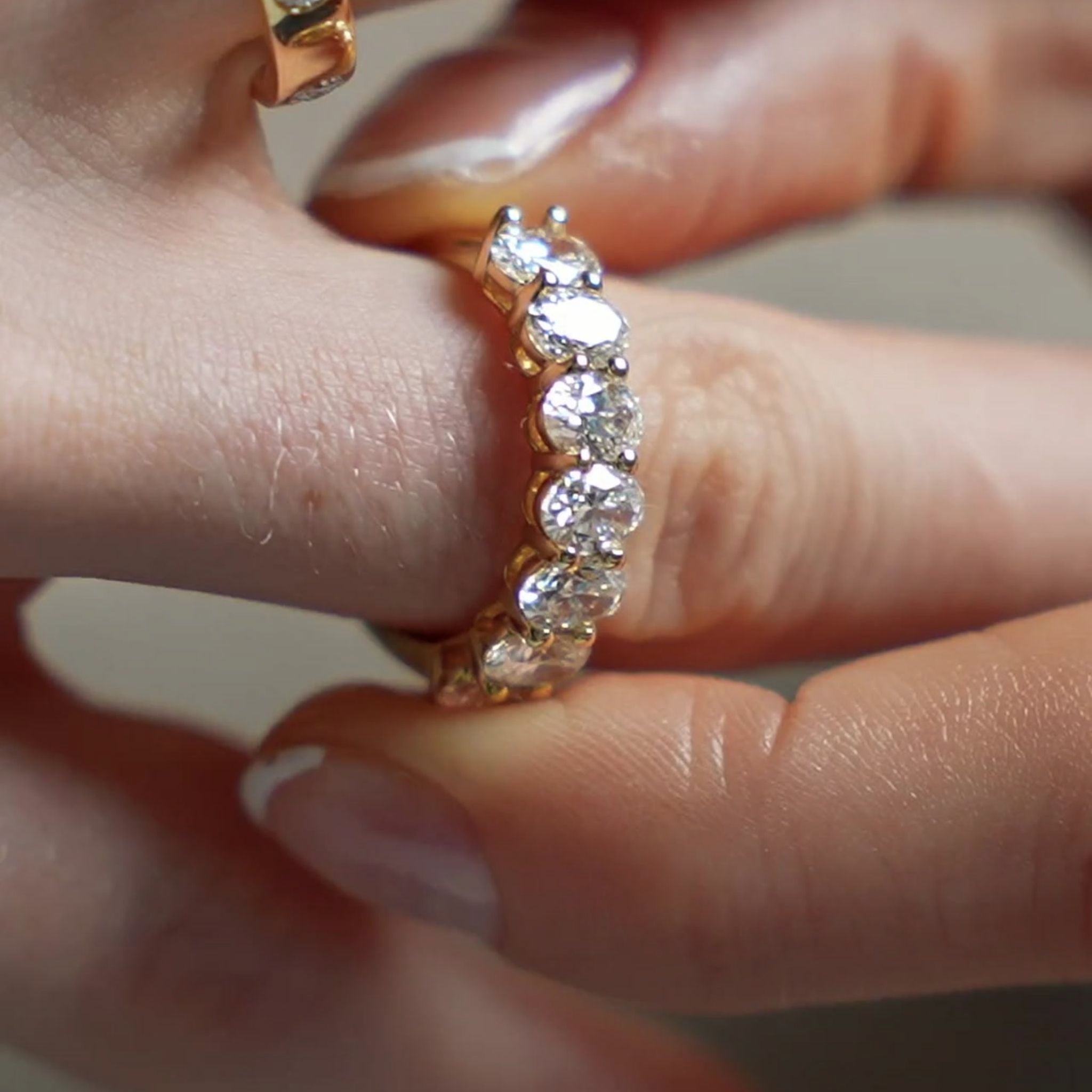 Diamond eternity ring with seven oval shaped diamonds