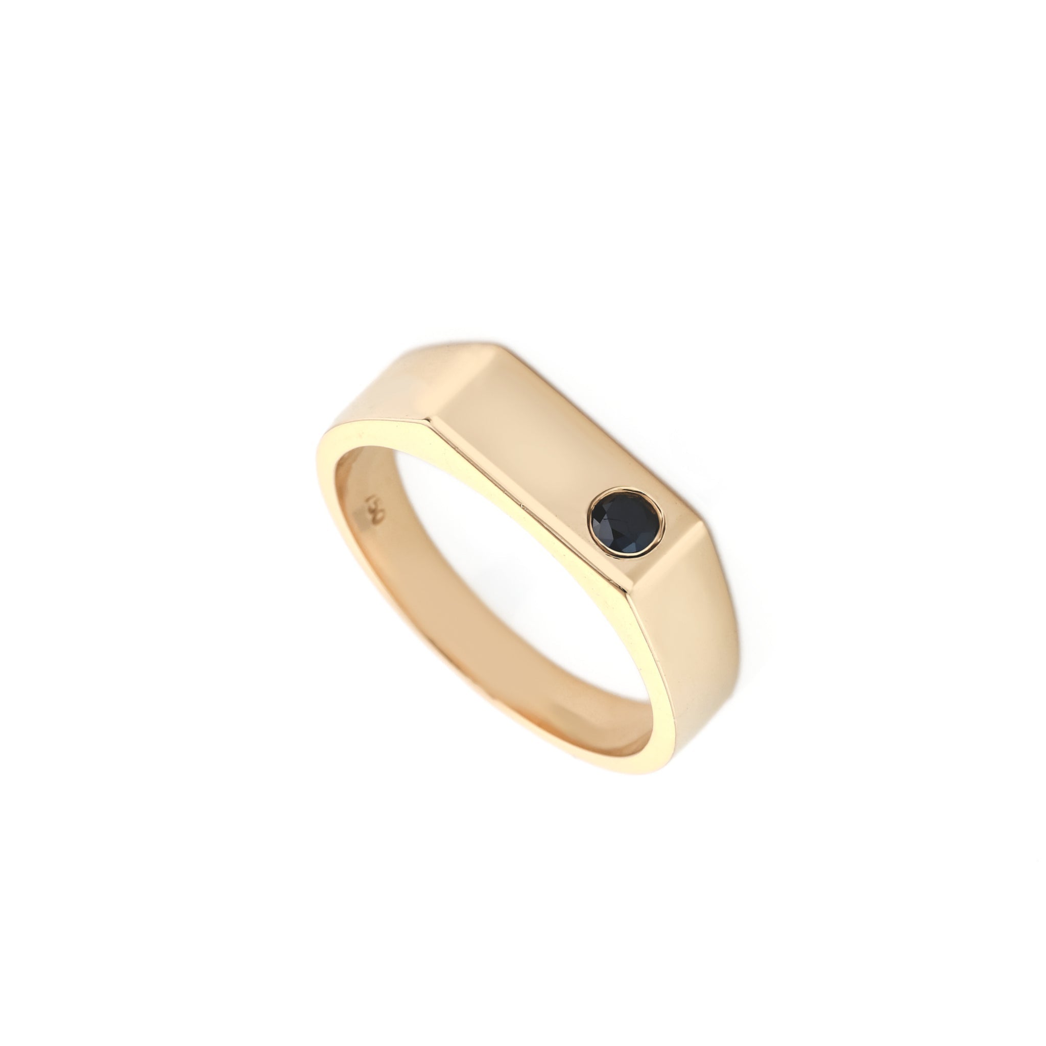 A gold-toned men's band ring with a small round black diamond inset on the front, shown on a plain white background.