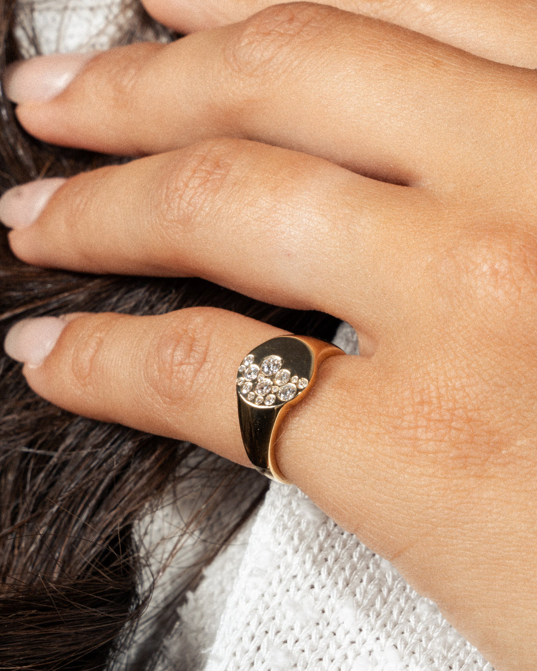 Elegant diamond ring featuring a unique design with a scattering of diamonds on a gold band.