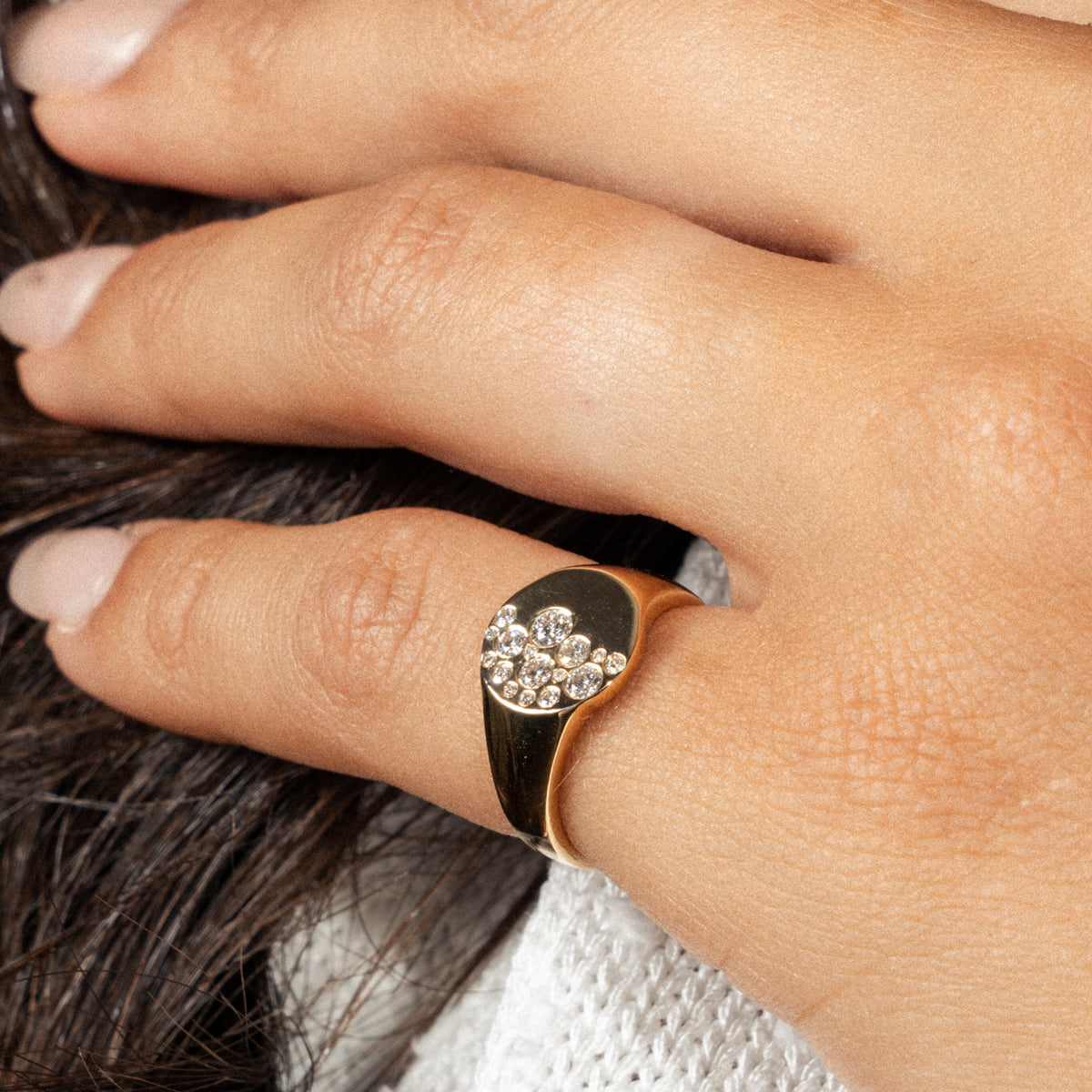 Elegant diamond ring featuring a unique design with a scattering of diamonds on a gold band.