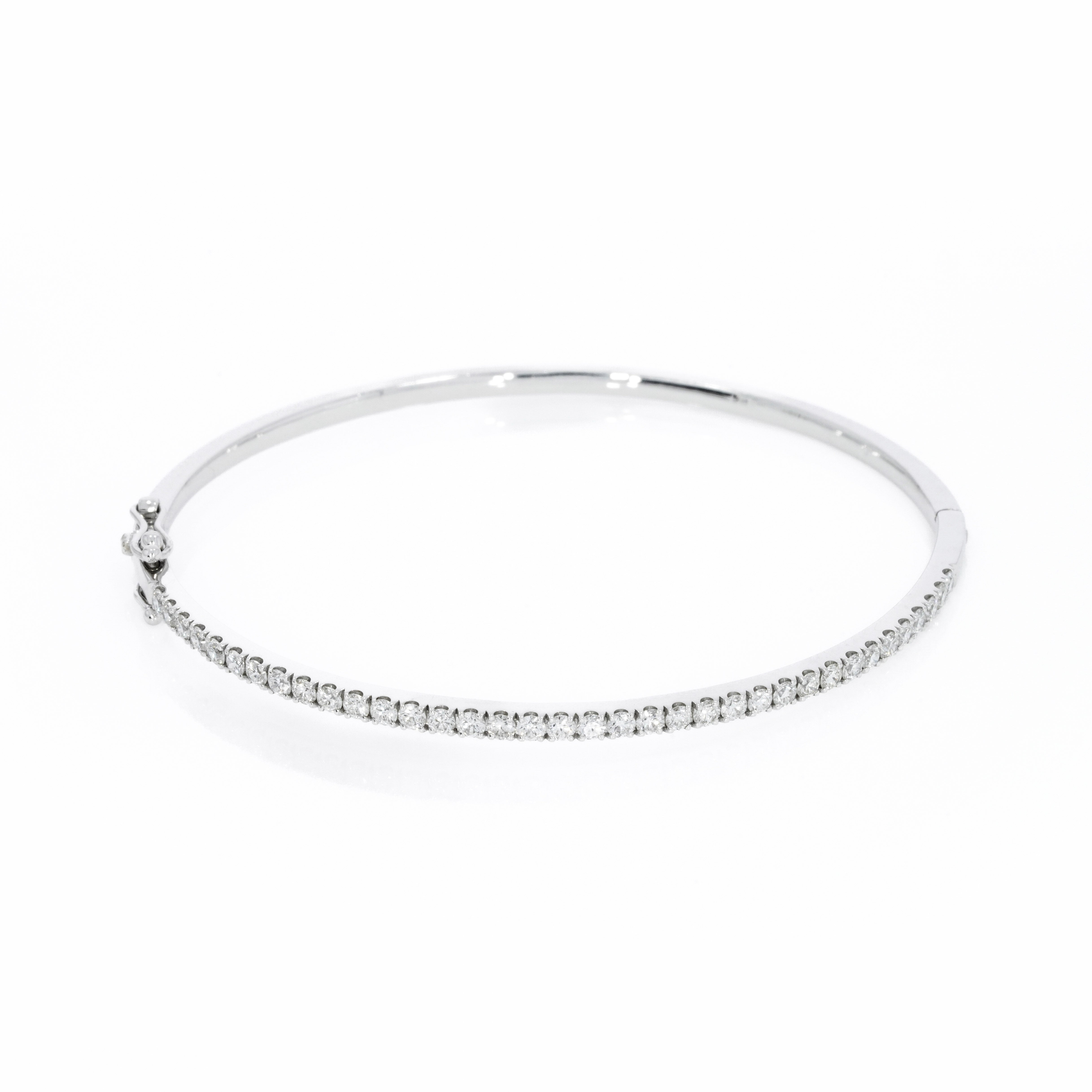 Diamond tennis bangle in solid 18ct gold featuring diamonds with a secure double lock clasp.