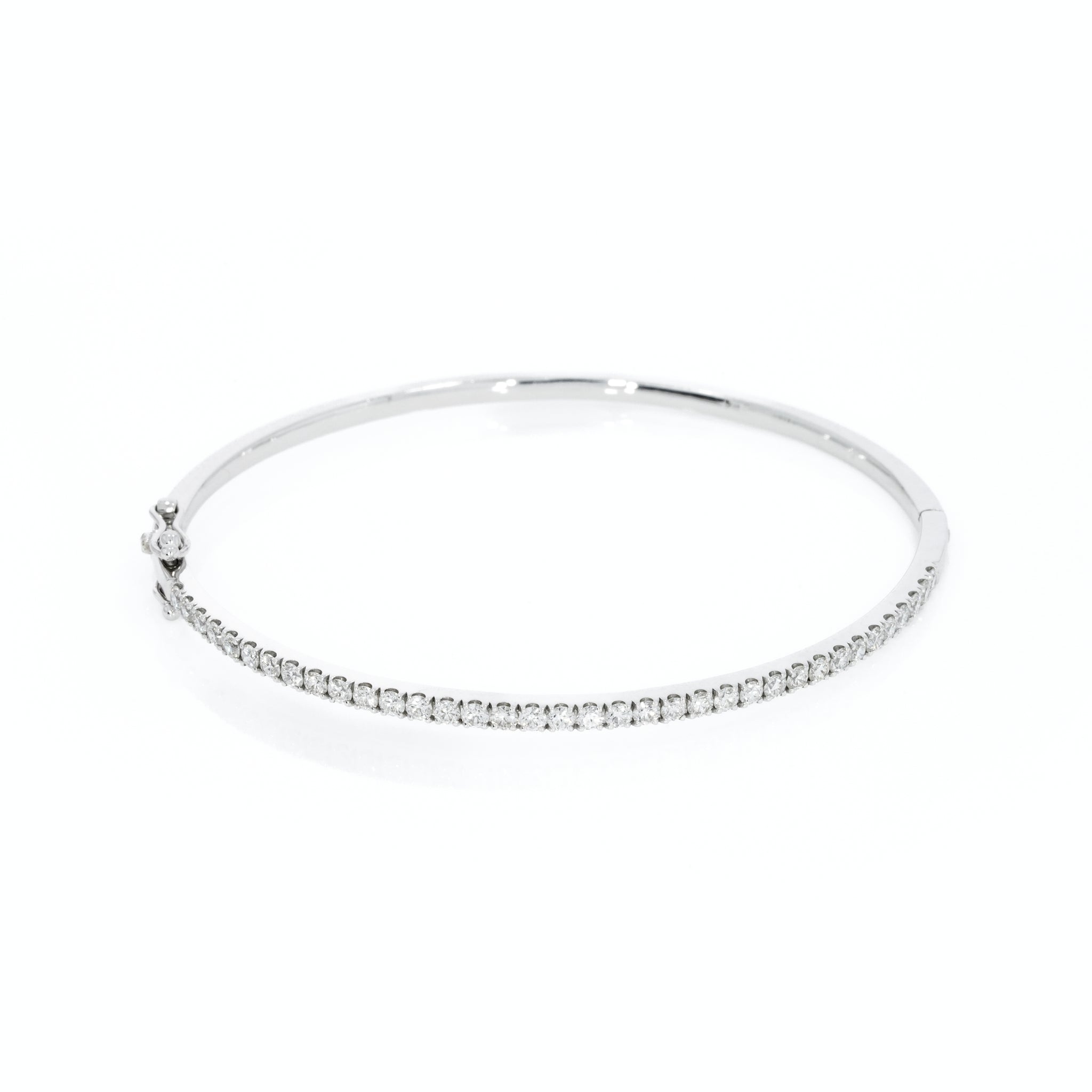 Diamond tennis bangle in solid 18ct gold featuring diamonds with a secure double lock clasp.