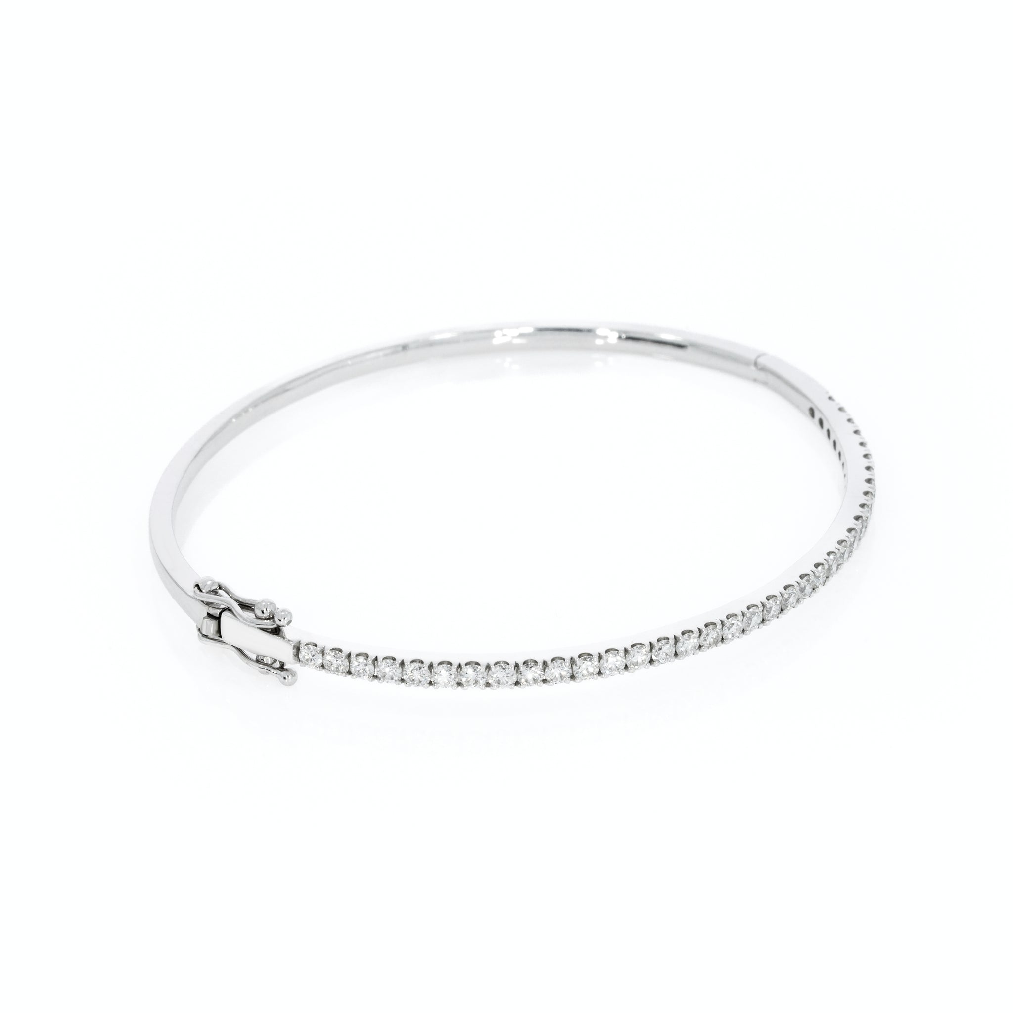 Tennis bangle in solid 18ct gold featuring diamonds with a secure double lock clasp.