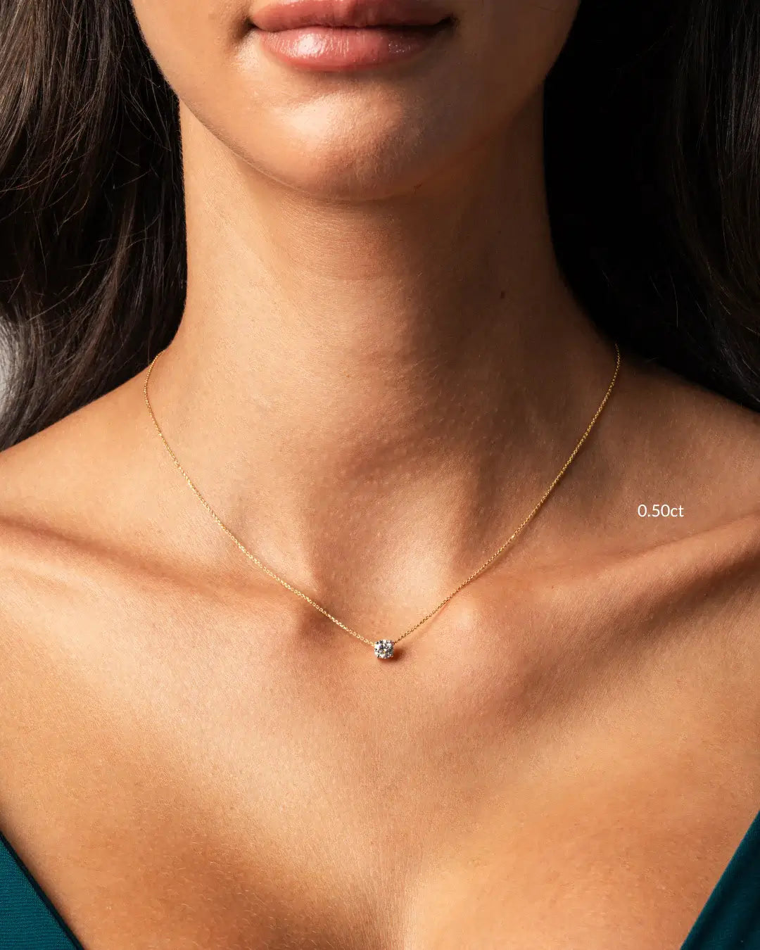 The Floating Diamond Necklace showcased on model, featuring a round diamond on a fine gold chain, highlighting elegant beauty.