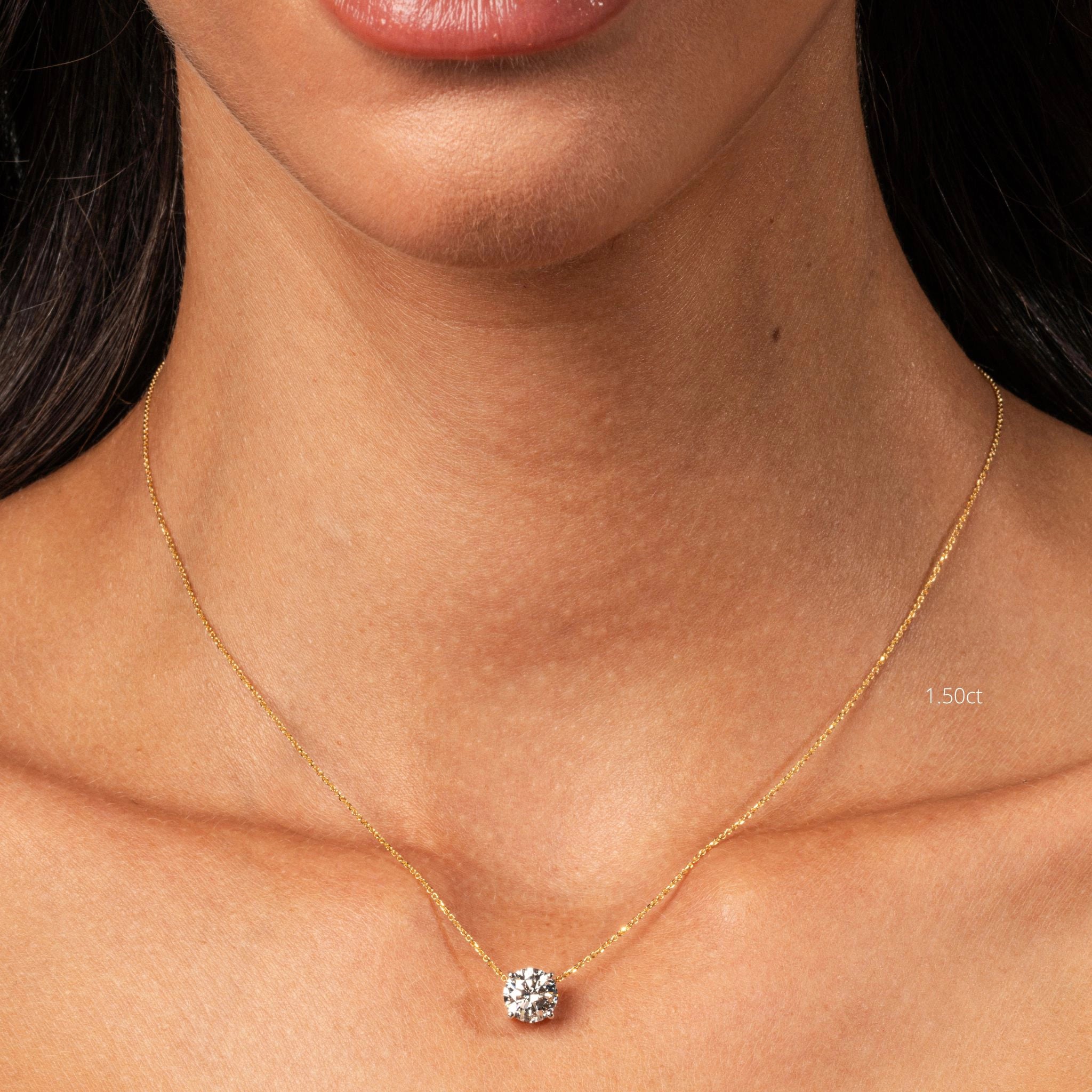 The Floating Diamond Necklace featuring a round brilliant cut diamond on a fine gold chain, worn with a choker.