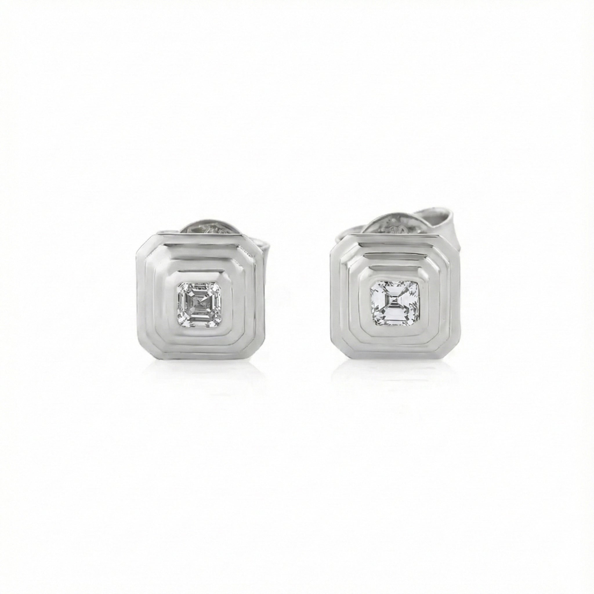 White Gold earrings with asscher cut diamonds on a white background
