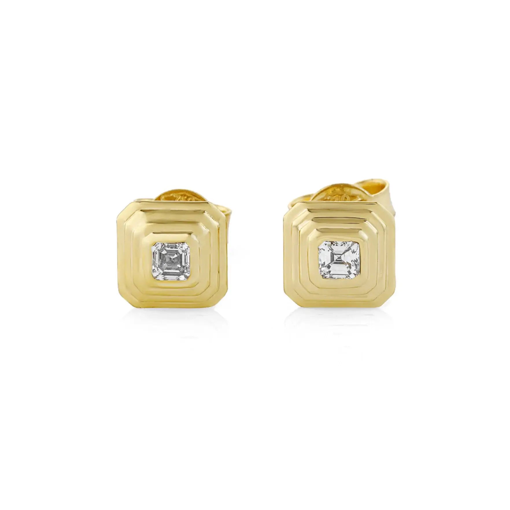Gold earrings with asscher cut diamonds on a white background