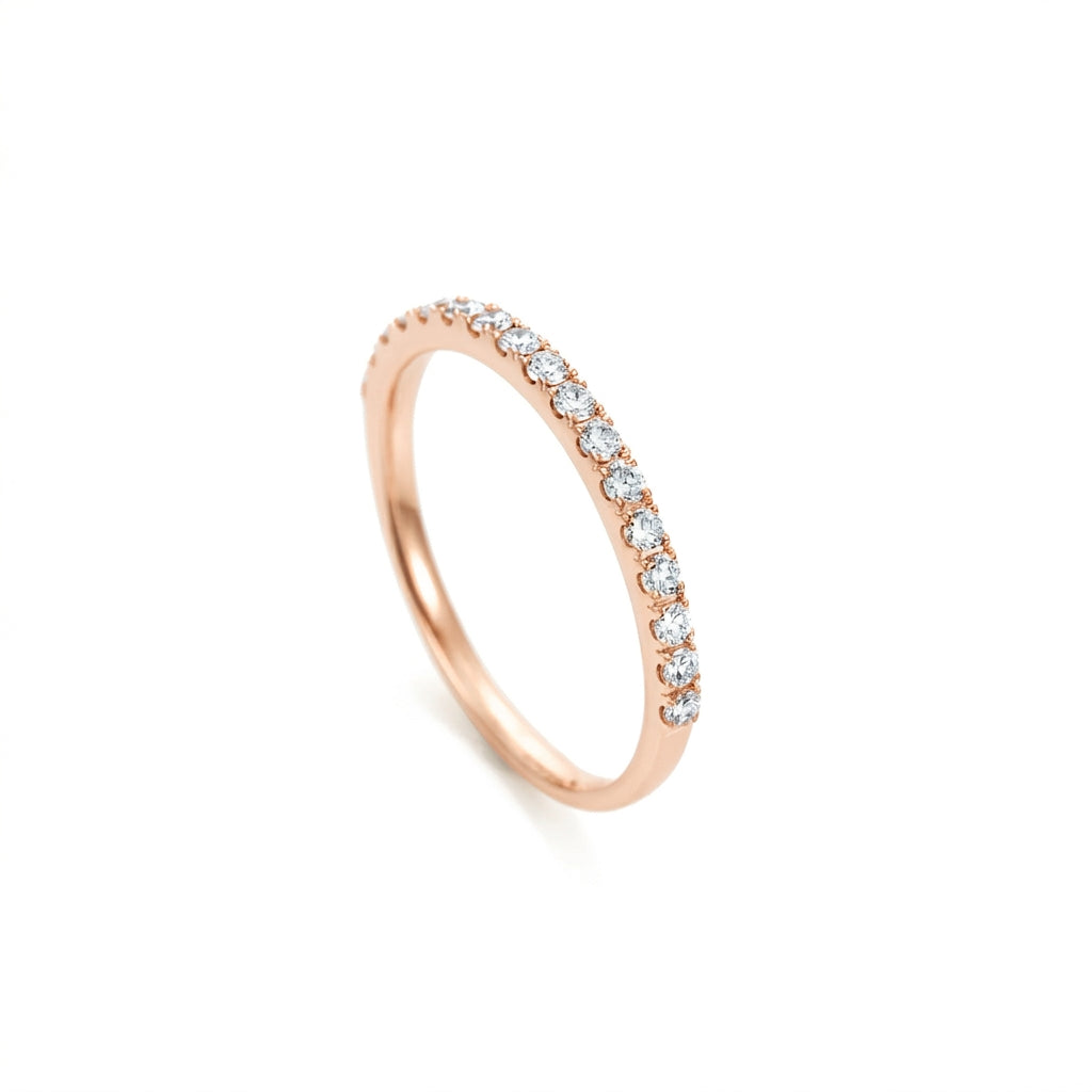 Rose gold ring with diamonds on a white background