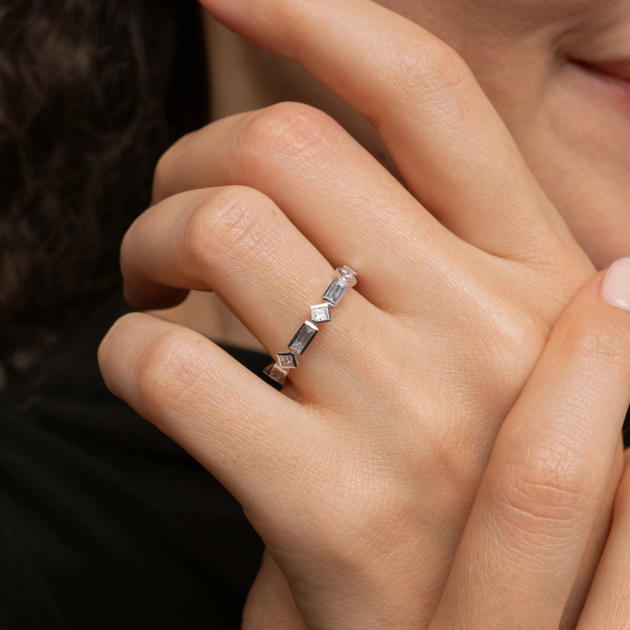 Woman wearing a modern baguette bezel diamond ring showcasing elegant design and sparkling stones.