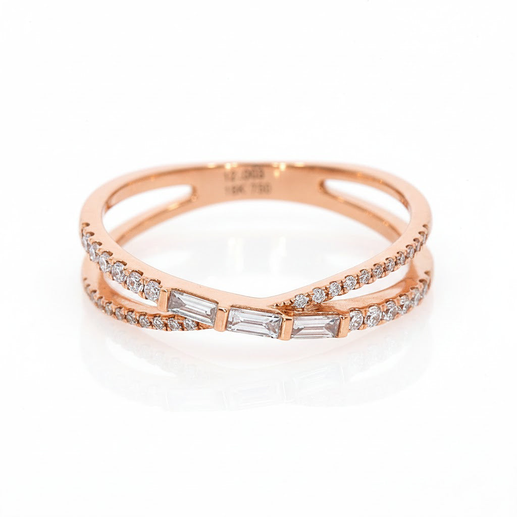 Baguette criss cross ring in 18ct gold with round cut diamonds enhancing the design.