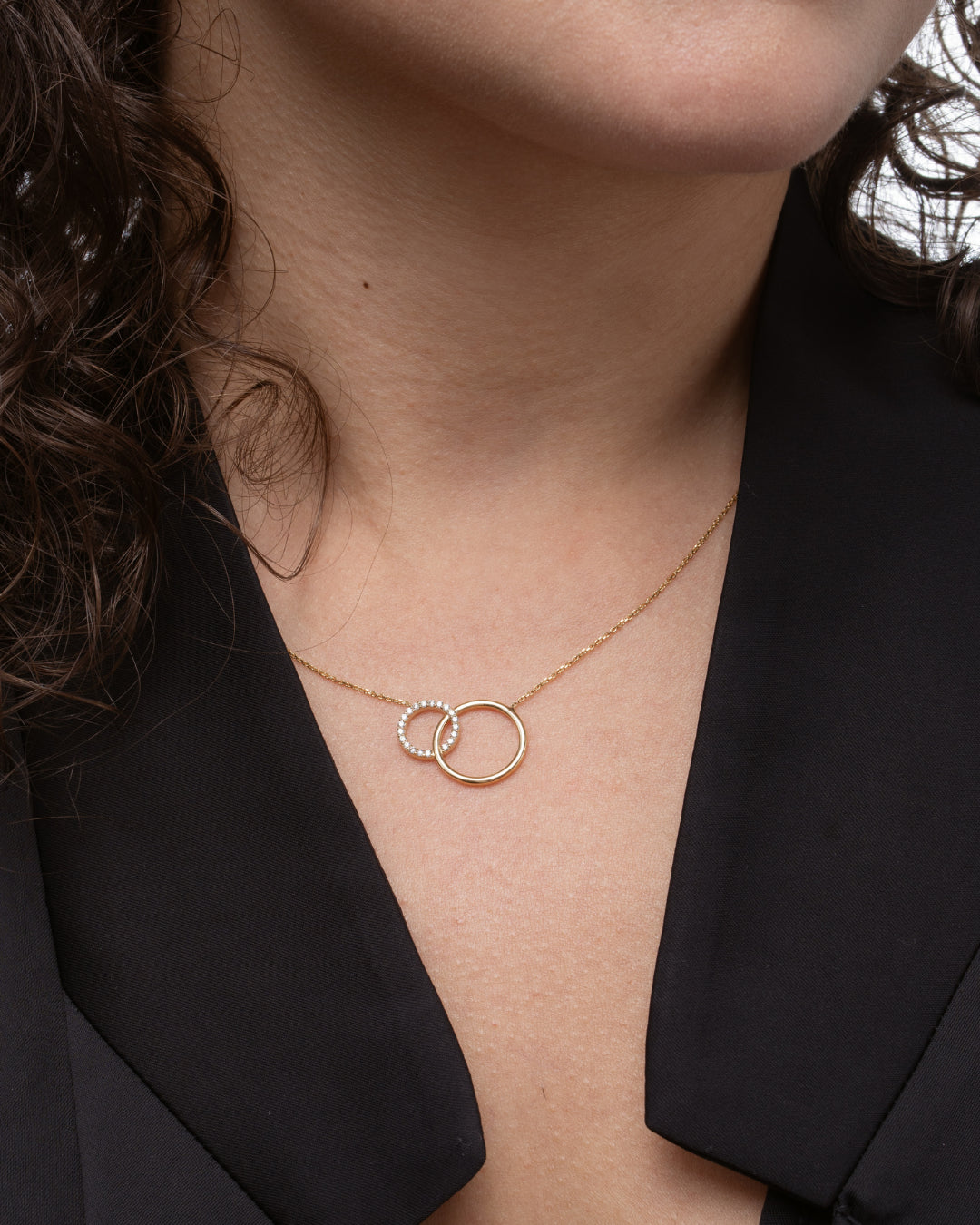 Close view of a circle and sparkle certified diamond necklace with two interlocking circles showcasing bright diamonds.