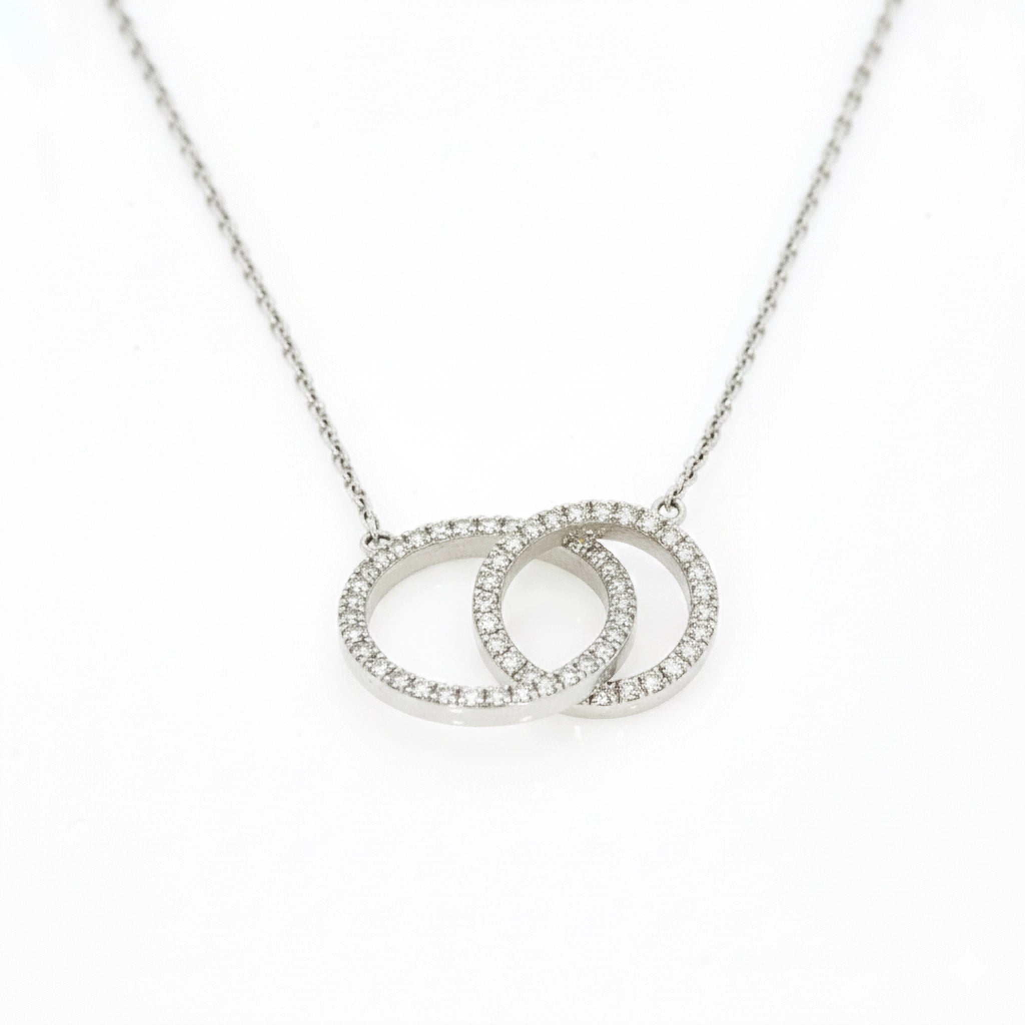 Circle Around The Sun necklace featuring interlocking diamond circles in 18ct white gold set with F-G colour diamonds.