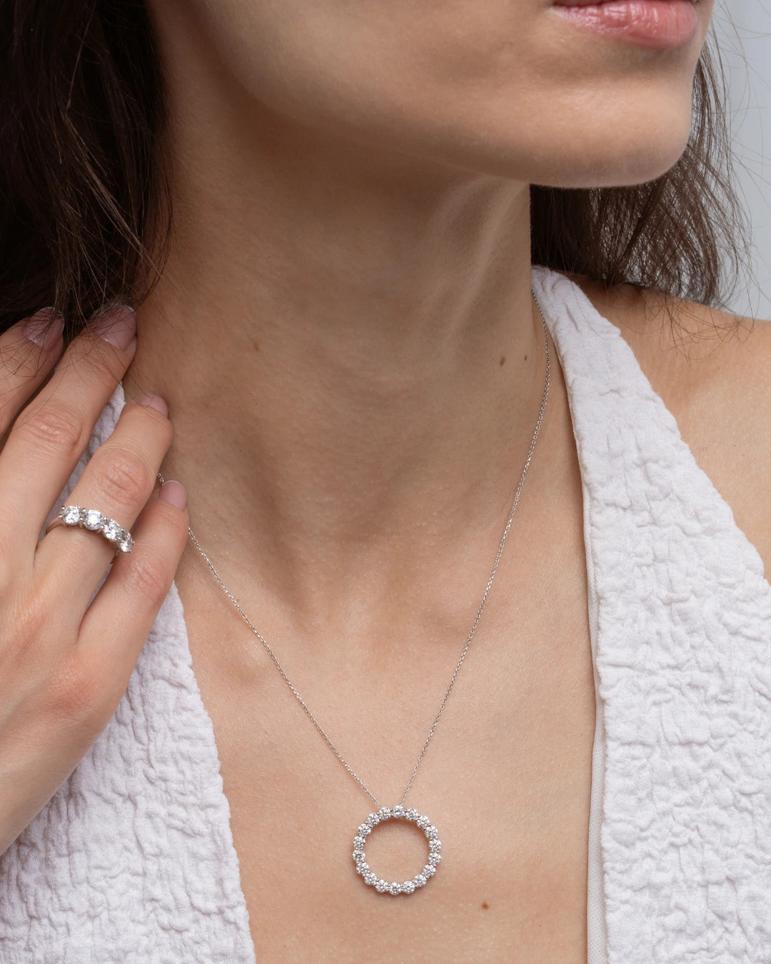 Close-up of a model wearing Circle Of Life Necklace - Large adorned with diamonds, showcasing its elegance and sparkle.
