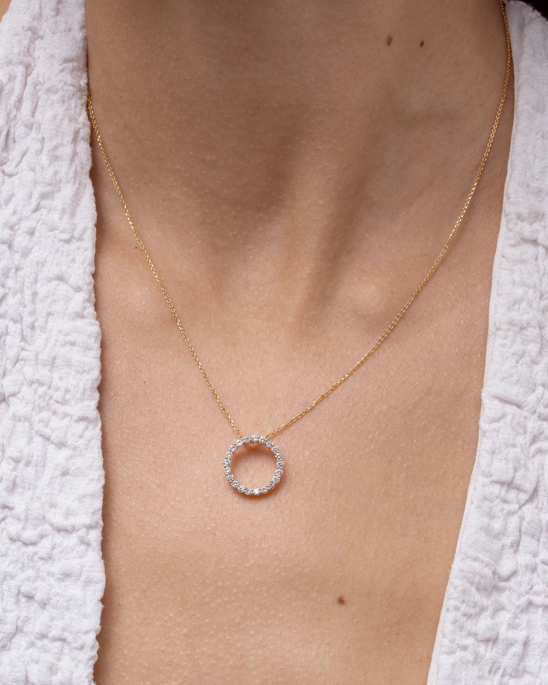 Close-up of the Circle Of Life Necklace - Small featuring brilliant diamonds on a delicate chain.