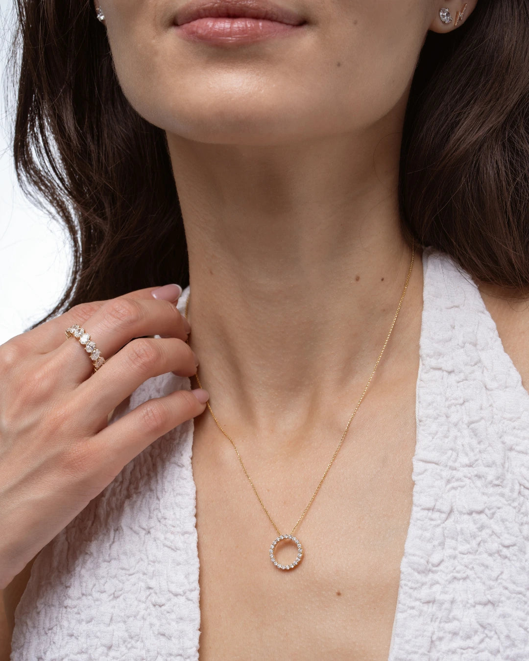 Woman wearing a Circle Of Life Necklace - Small with diamonds, showcasing its elegance and sparkle.
