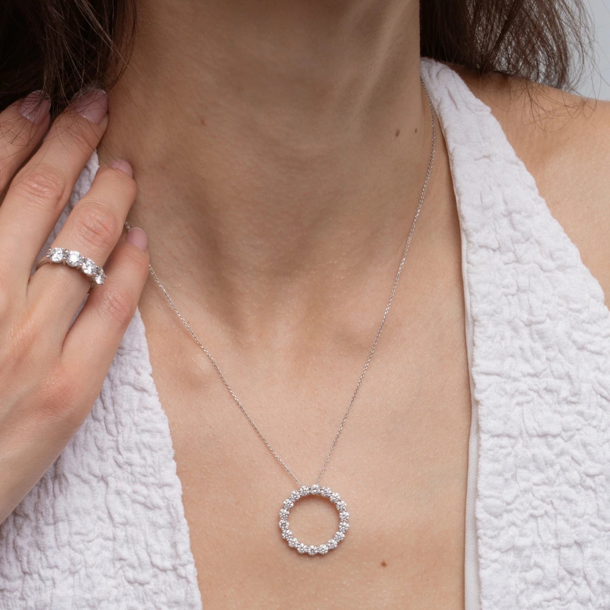 Close-up of a model wearing Circle Of Life Necklace - Large adorned with diamonds, showcasing its elegance and sparkle.