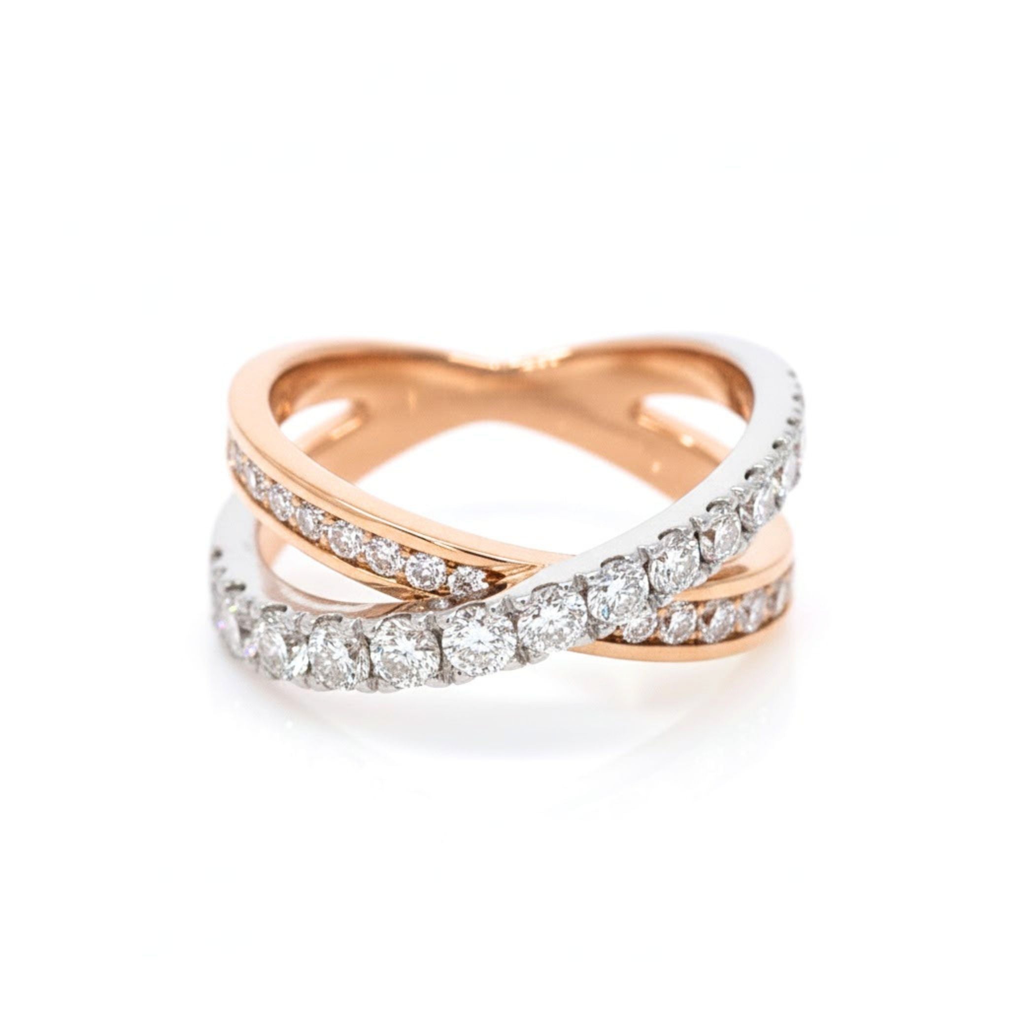 Rose and white gold criss cross ring with diamonds on a white background