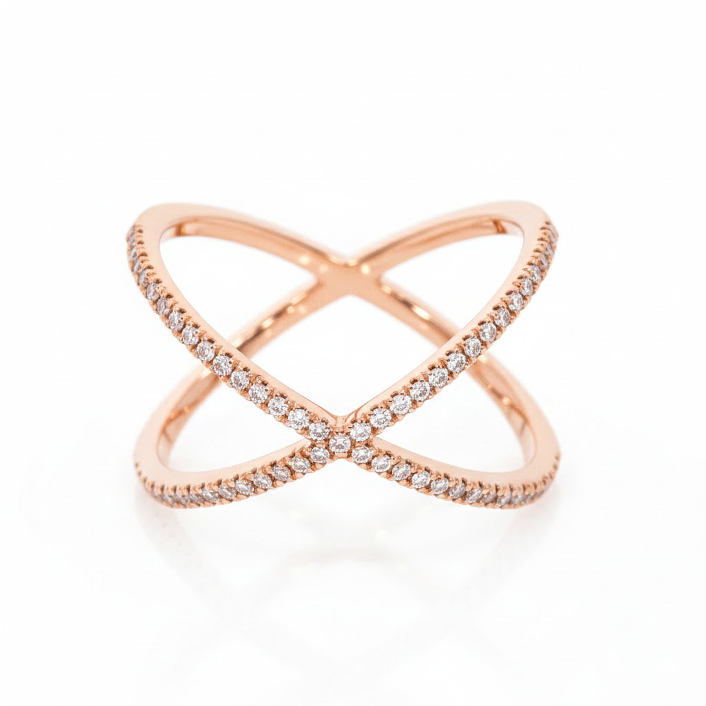 Criss cross diamond ring in rose gold with sparkling diamonds intersecting each other.