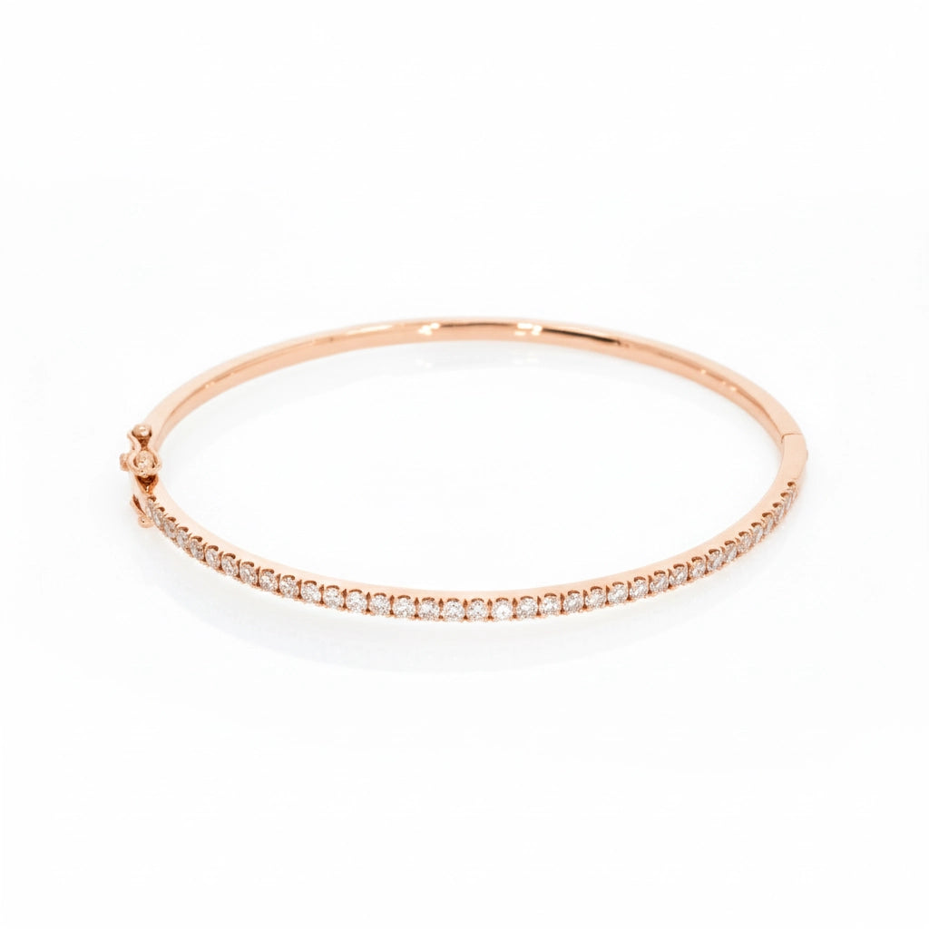 Tennis bangle in solid 18ct rose gold featuring diamonds with a secure double lock clasp.