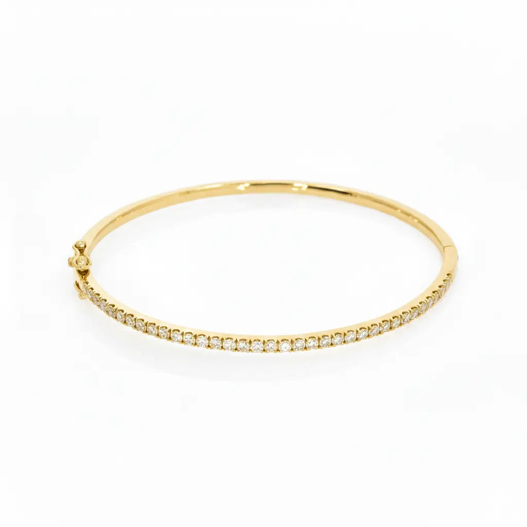 Tennis bangle in solid 18ct yellow gold featuring diamonds with a secure double lock clasp.
