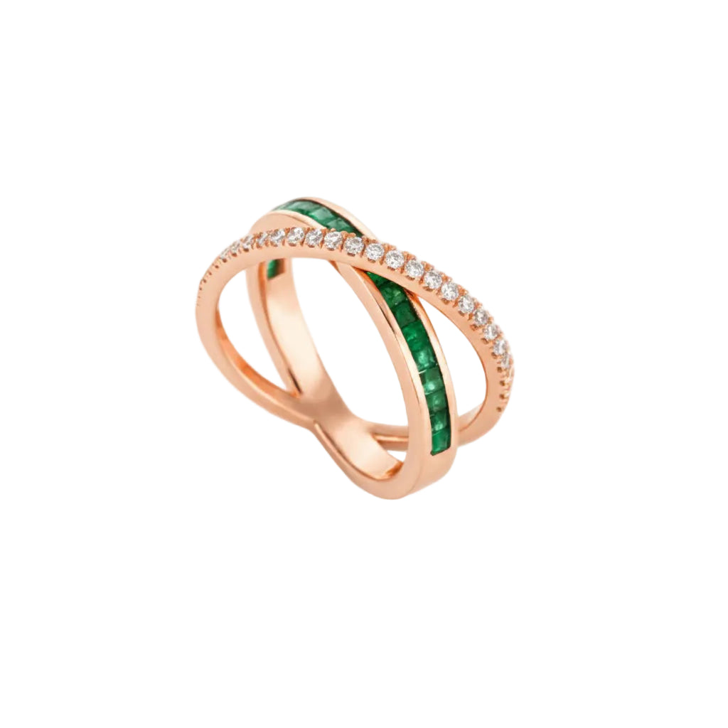 Rose gold criss cross ring with emeralds and small diamonds on a white background