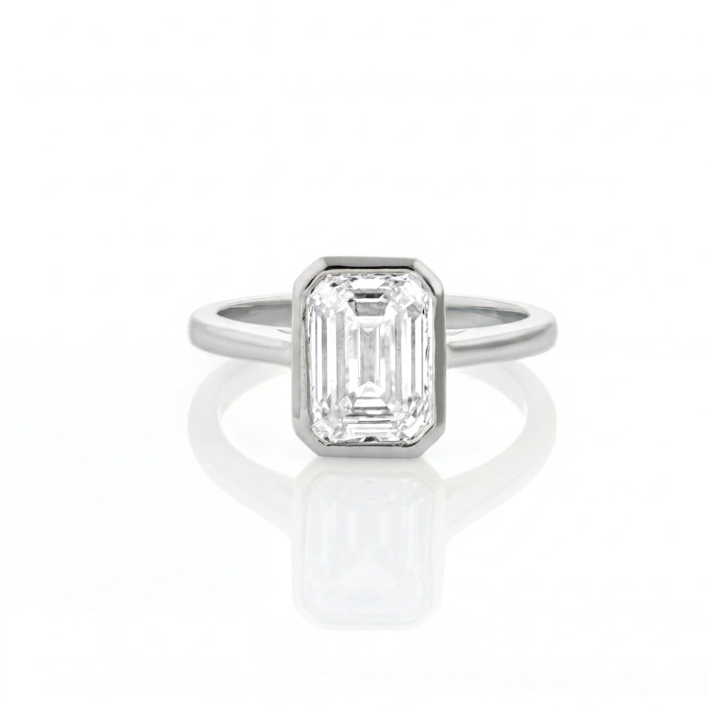 Bezel Set Emerald Cut Diamond Ring with a certificated diamond in white gold colour