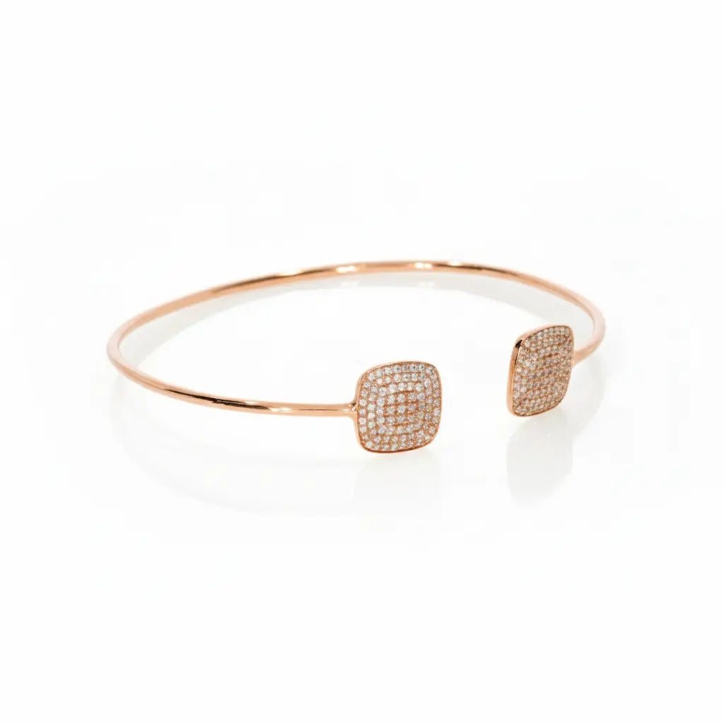 Elegant rose gold diamond bangle featuring certified diamond clusters in square designs, shining beautifully on the wrist.