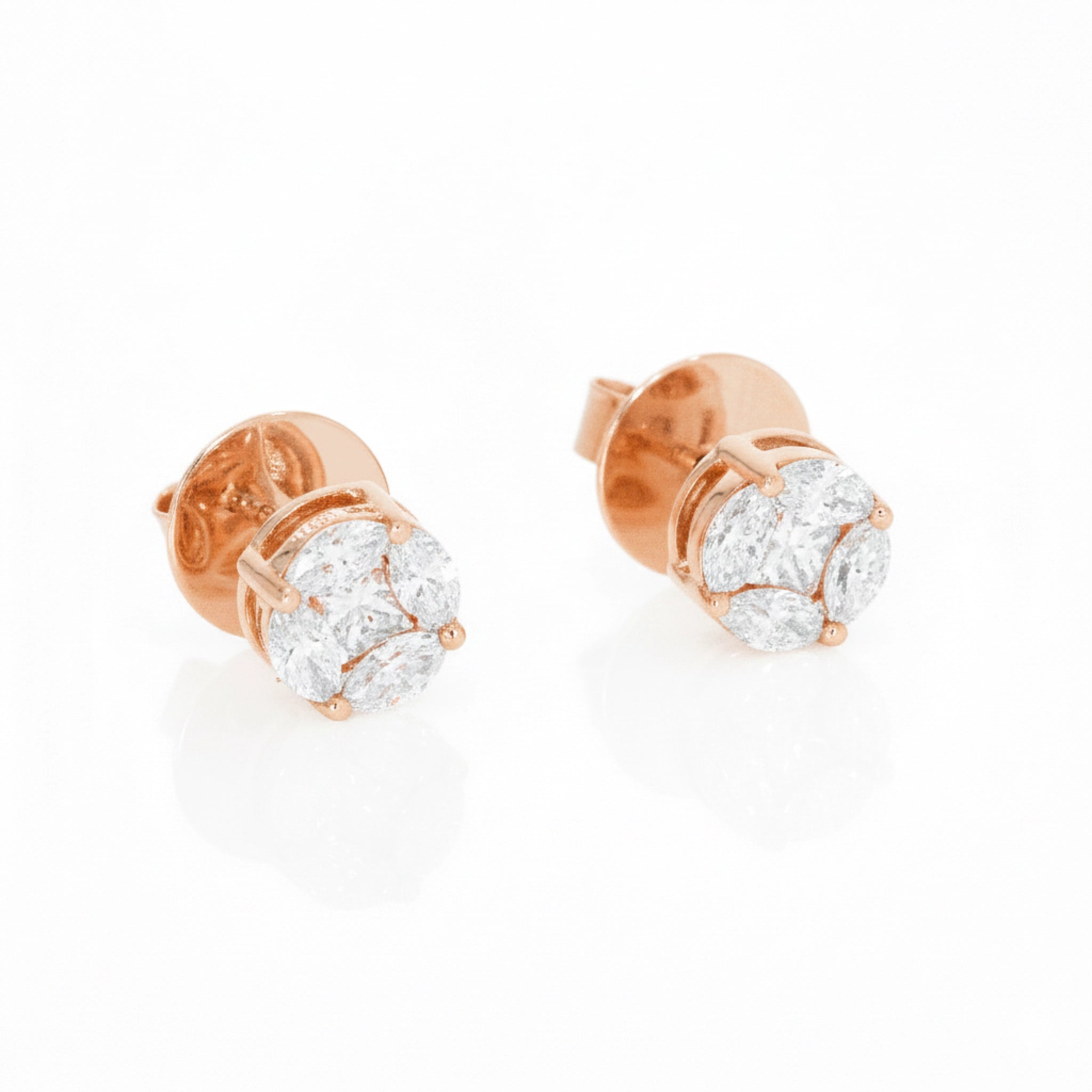 Rose gold earrings with diamonds on a white background