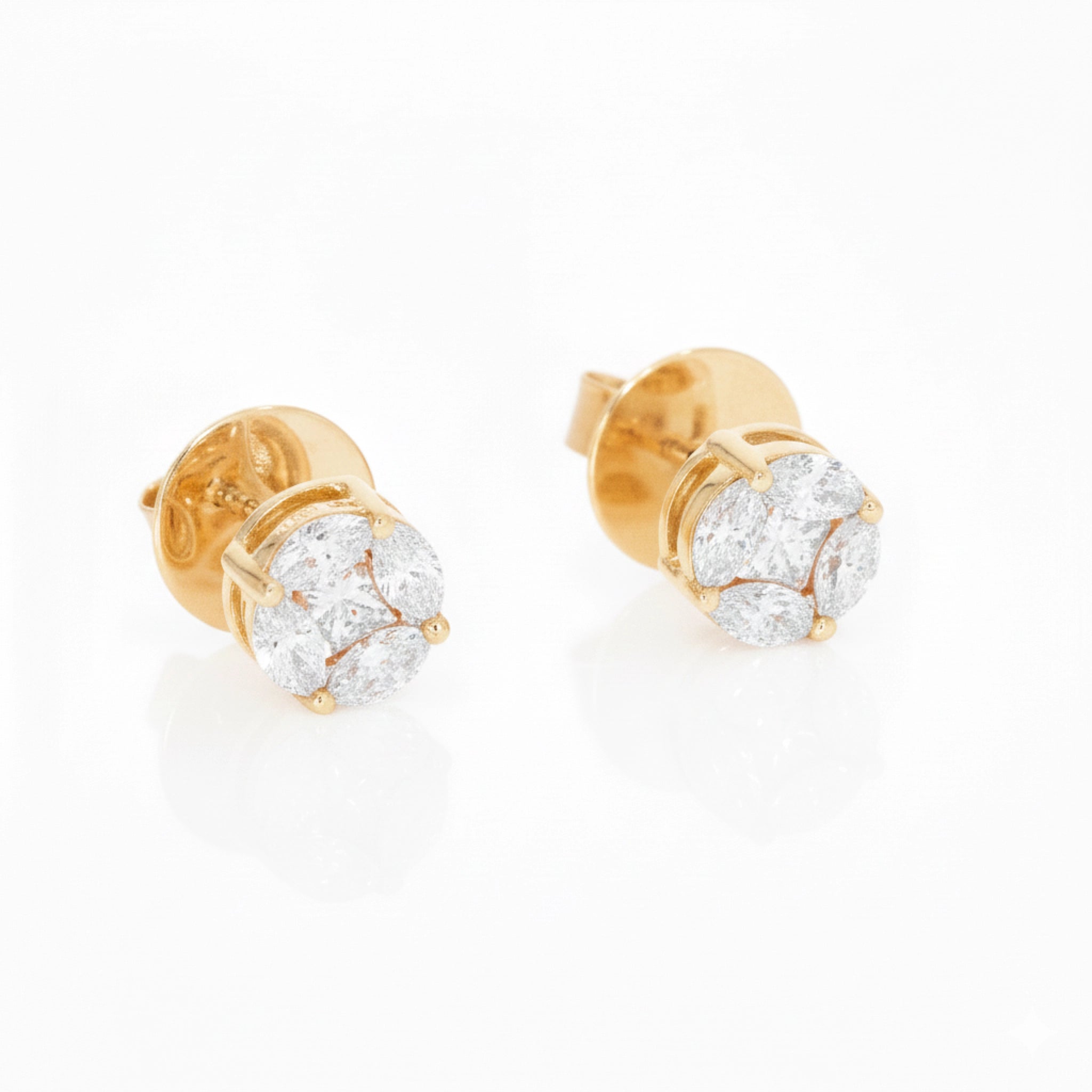 Gold stud earrings with diamonds on a white background