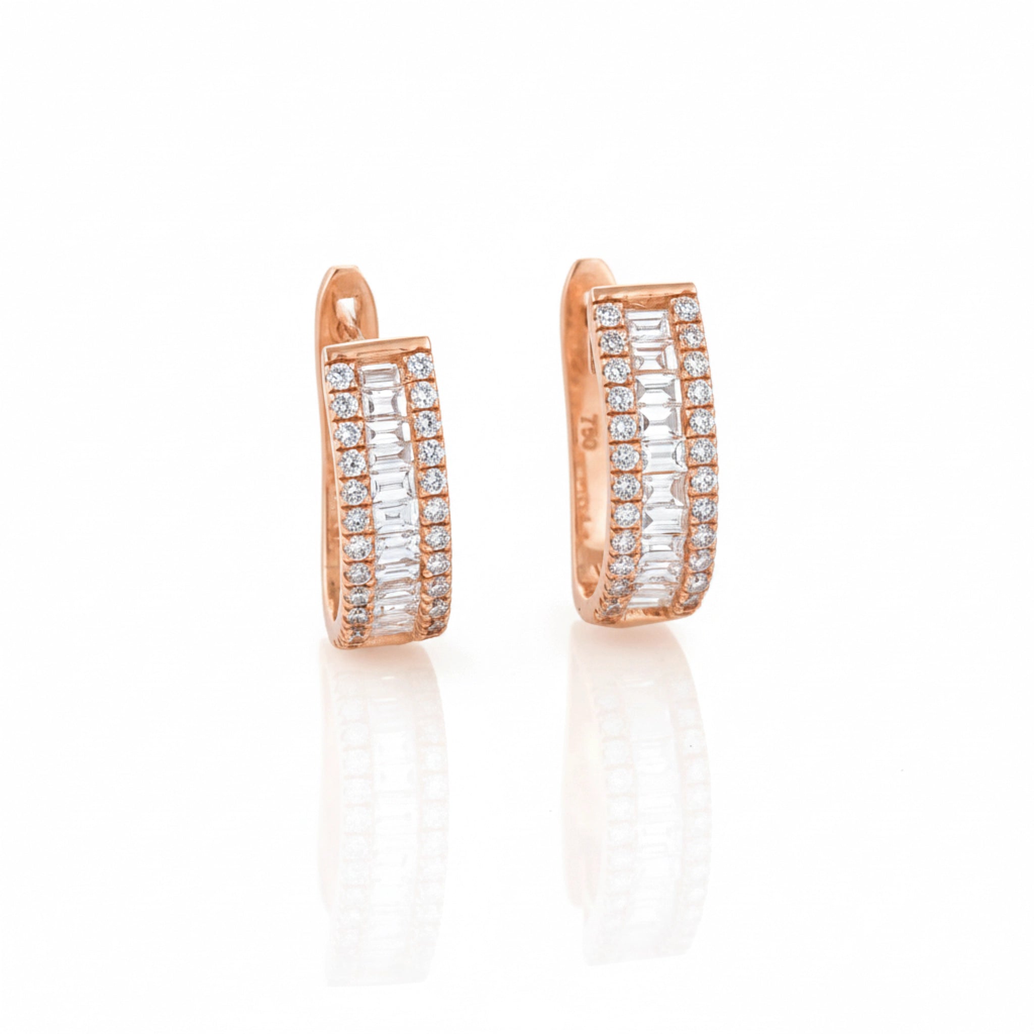 Rose gold hoop earrings with diamonds on a white background