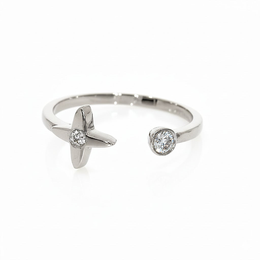 Mini Star Ring featuring a star design and a round brilliant cut diamond on an elegant band.