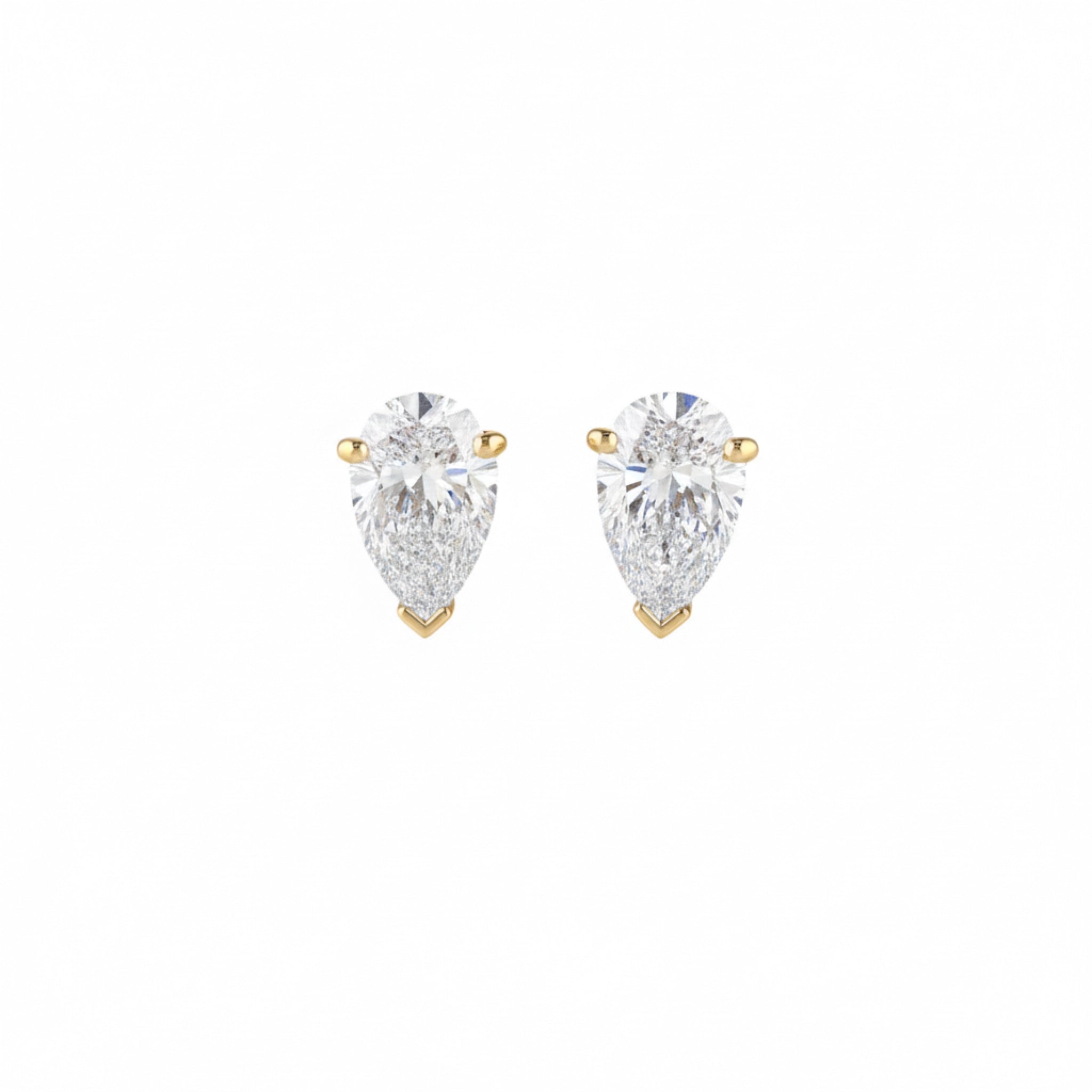 Pair of pear-shaped diamond earrings on a white background