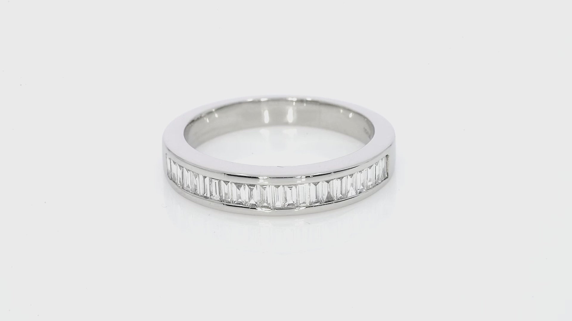 Channel set diamond baguette ring featuring certified diamonds in F-G colour and VS-SI clarity.