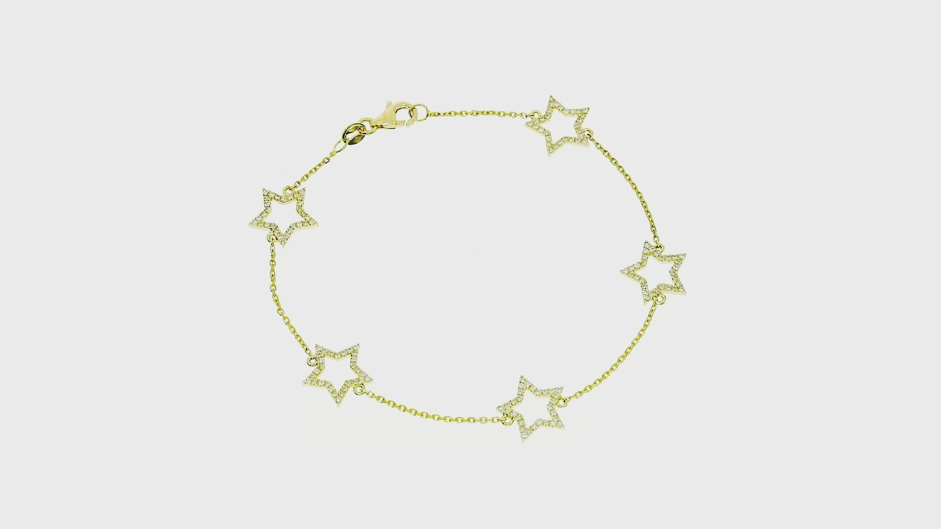 Elegant diamond-set star bracelet in 18ct gold, featuring five star motifs on a delicate chain.