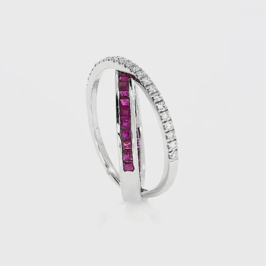 Ruby criss cross ring featuring princess cut red rubies and round brilliant cut diamonds set in white gold.