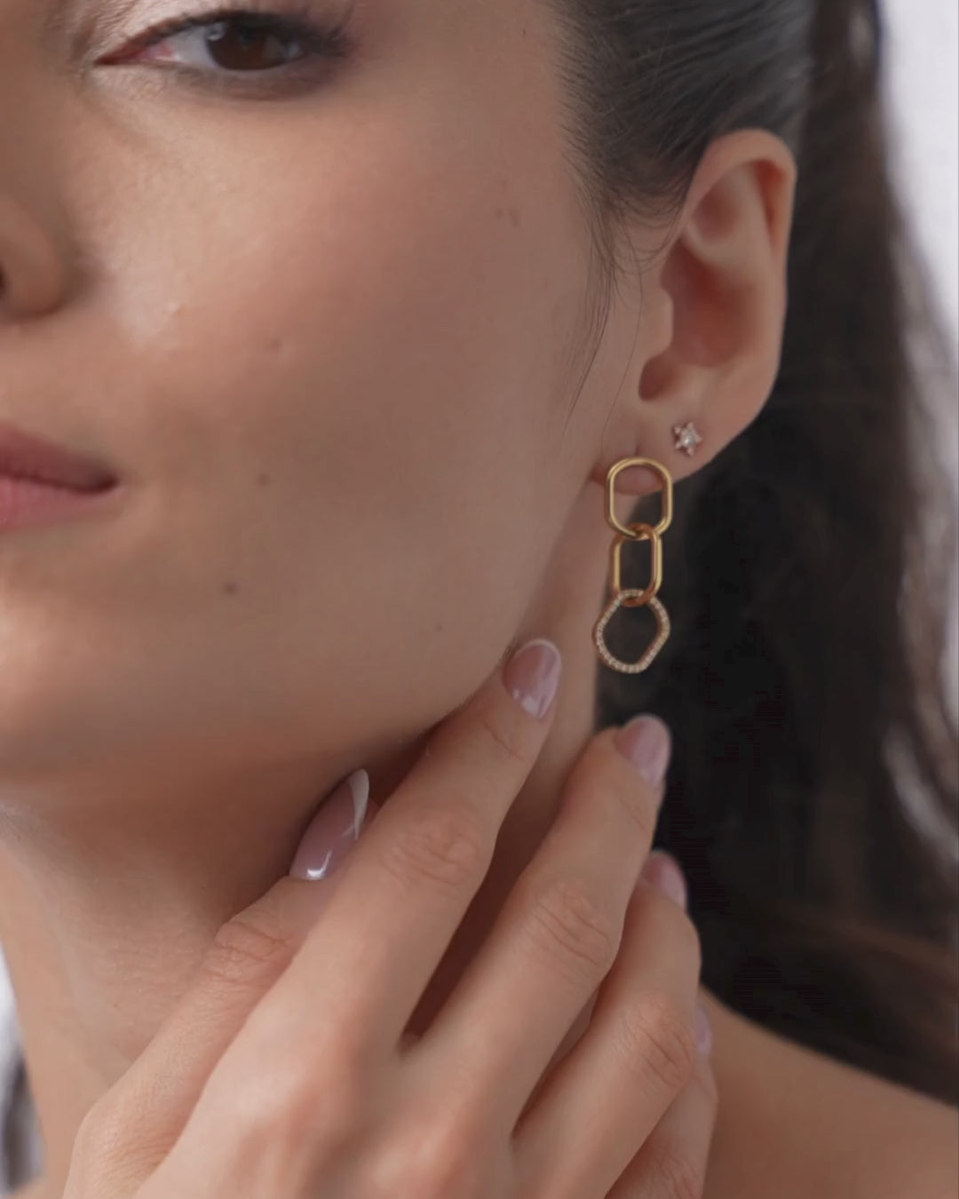 Elegant model showcasing chain link diamond earrings with interlocking gold links and certified diamonds.