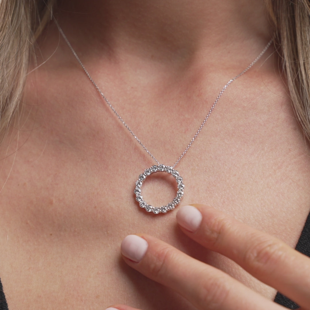 Circle Of Life Necklace - Large showcasing exquisite diamonds on a delicate chain worn on a woman's neck.