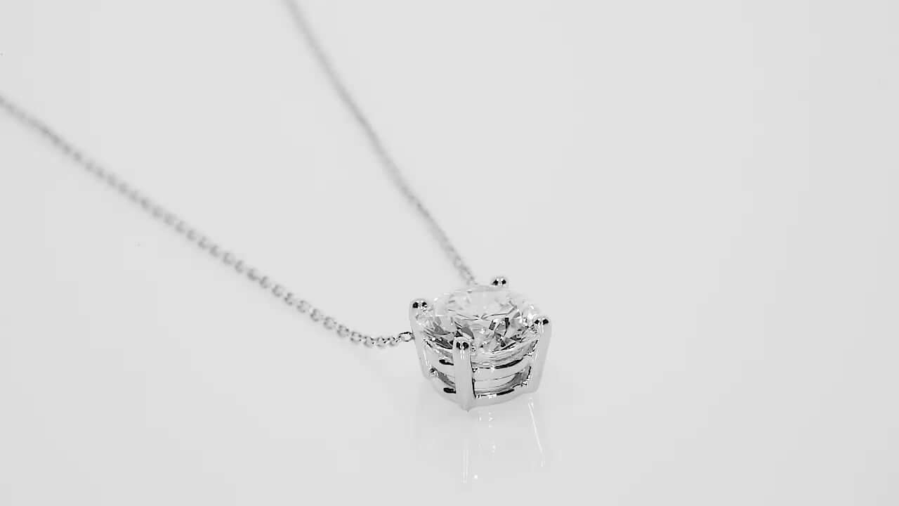 Elegant gold necklace with a floating diamond, showcasing a round brilliant cut in a classic setting.