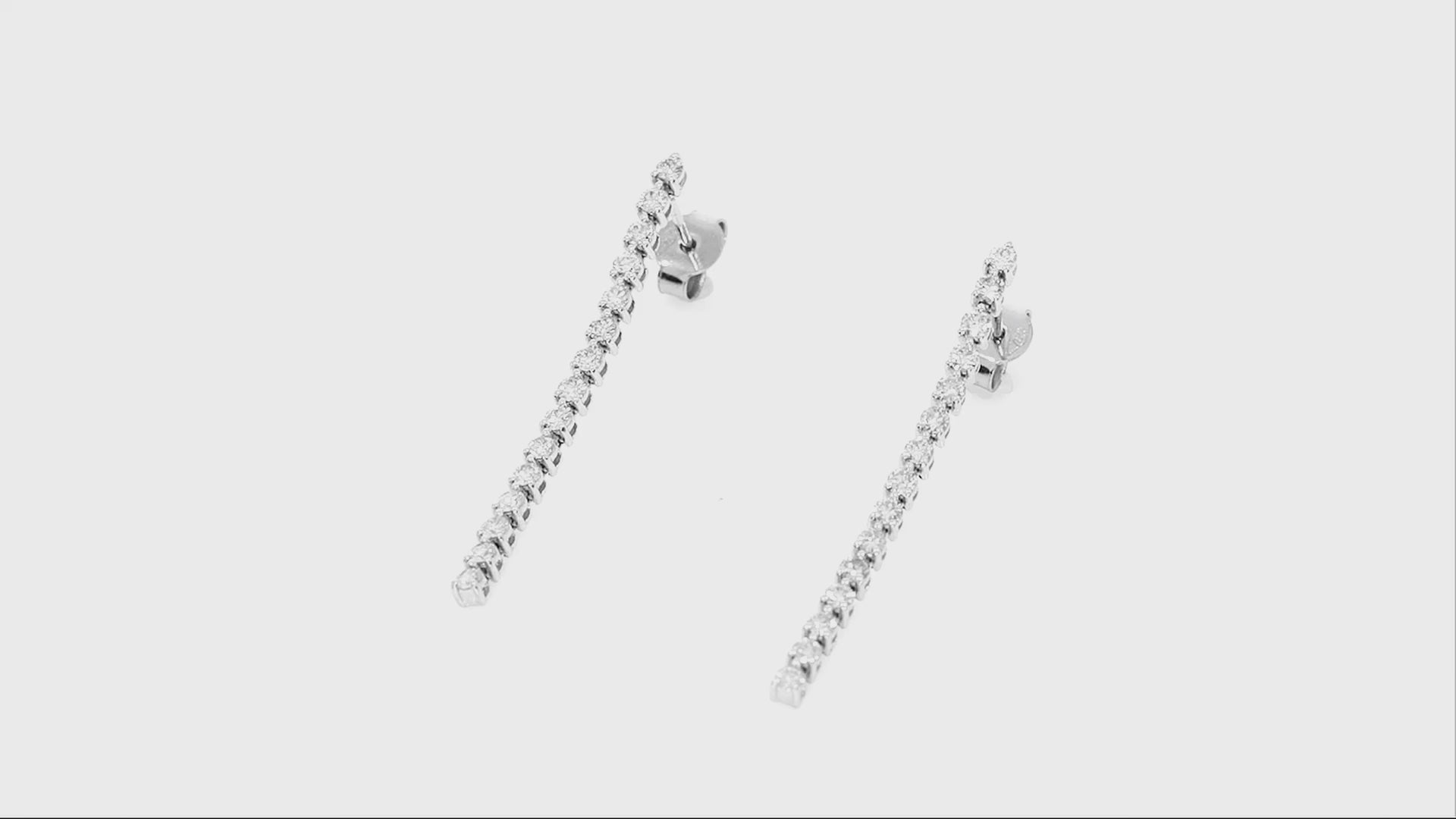 Elegant diamond earrings in a cascading design featuring round brilliant cut diamonds set in 18ct gold.