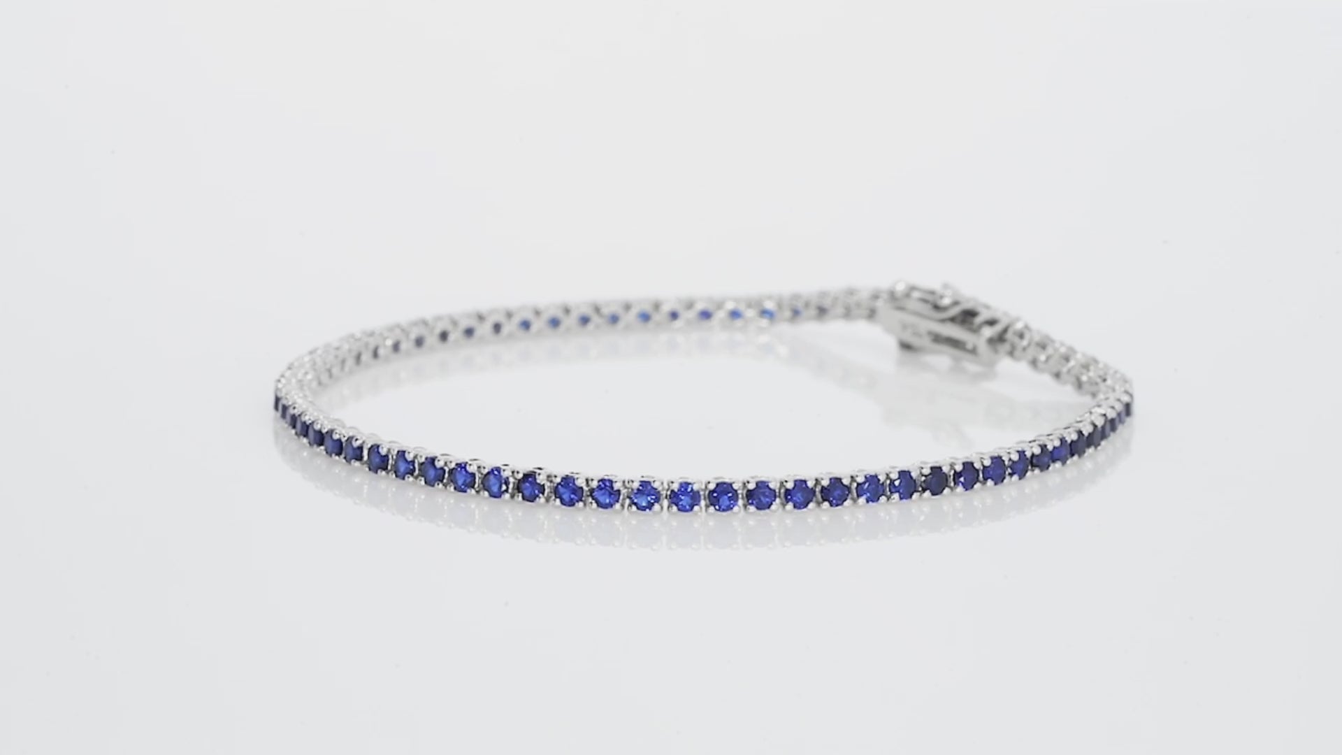 Sapphire tennis bracelet in 18ct white gold featuring vibrant blue gemstones for a luxurious look.