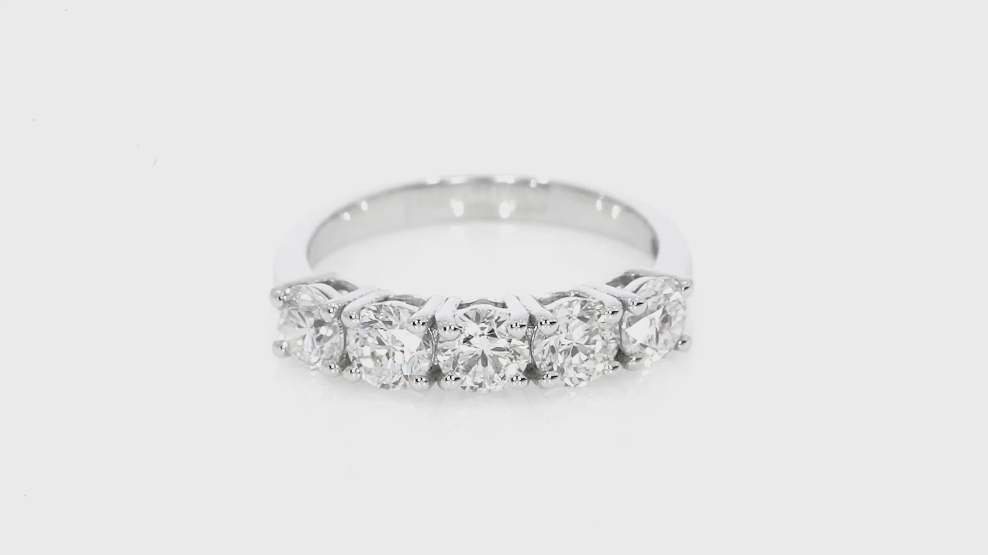 Classic Five Stone Eternity ring with round brilliant cut diamonds, set in a modern open basket setting for bright white sparkle