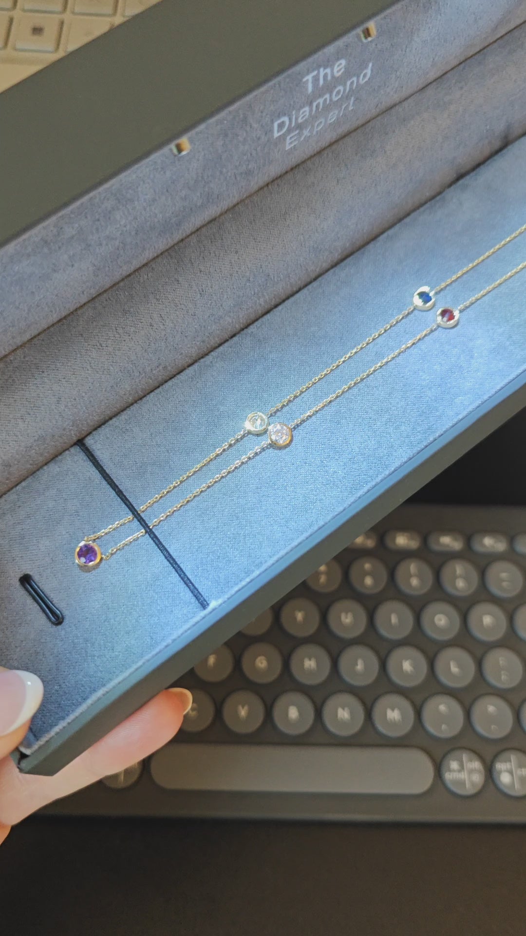 Constellation necklaces featuring birthstones in a stylish presentation box, showcasing delicate design and vibrant gemstones.