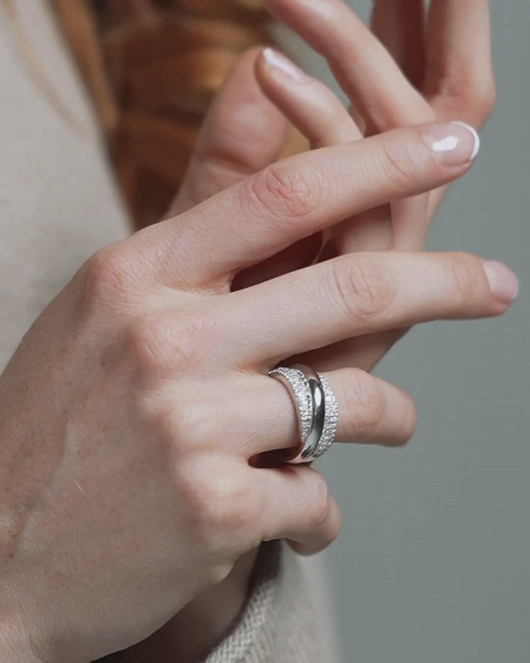 Close-up of a hand wearing a certified diamond ring with intricate design and sparkle