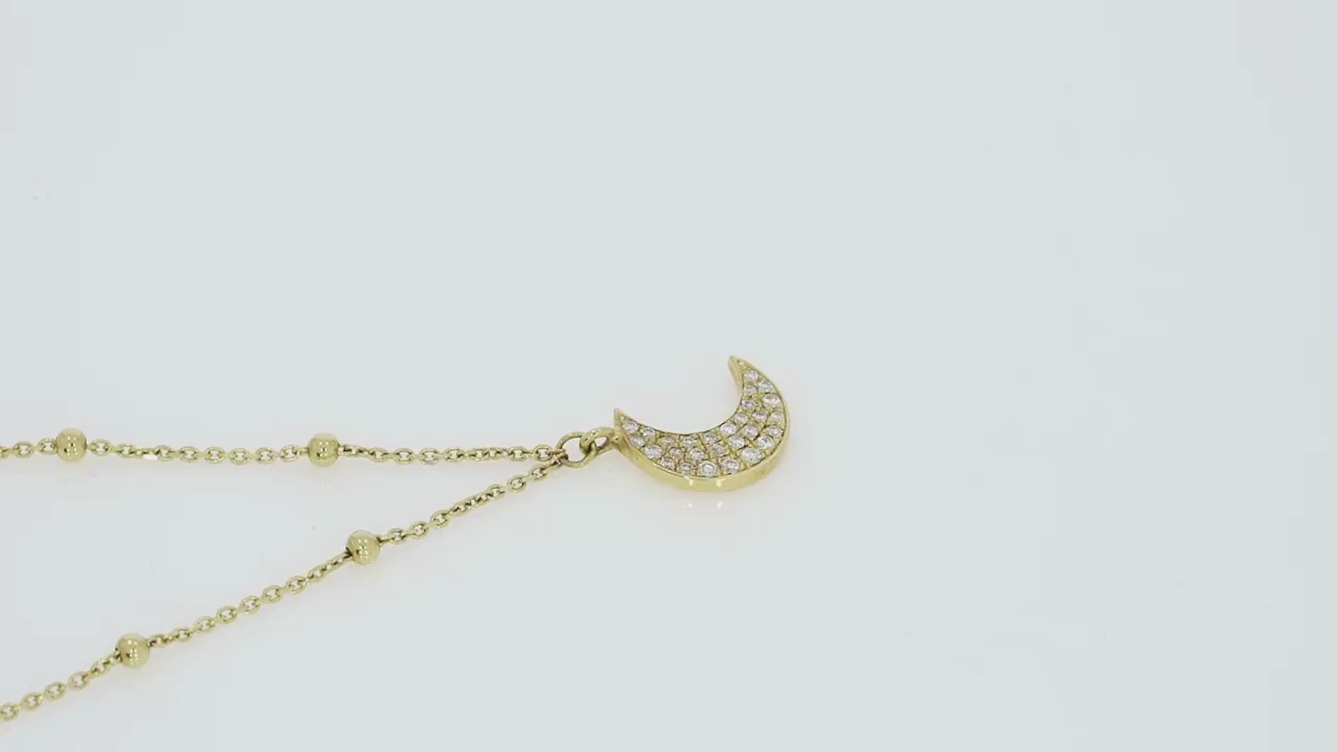Stunning  diamond necklace featuring a half moon pendant on a modern ball chain, sparkling brightly.