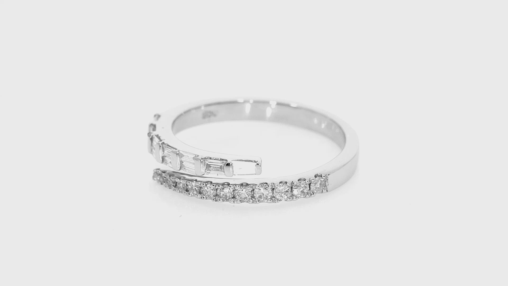 Luxury fine wrap ring with sparkly round brilliant and baguette cut diamonds, set in 18ct gold in white gold colour.