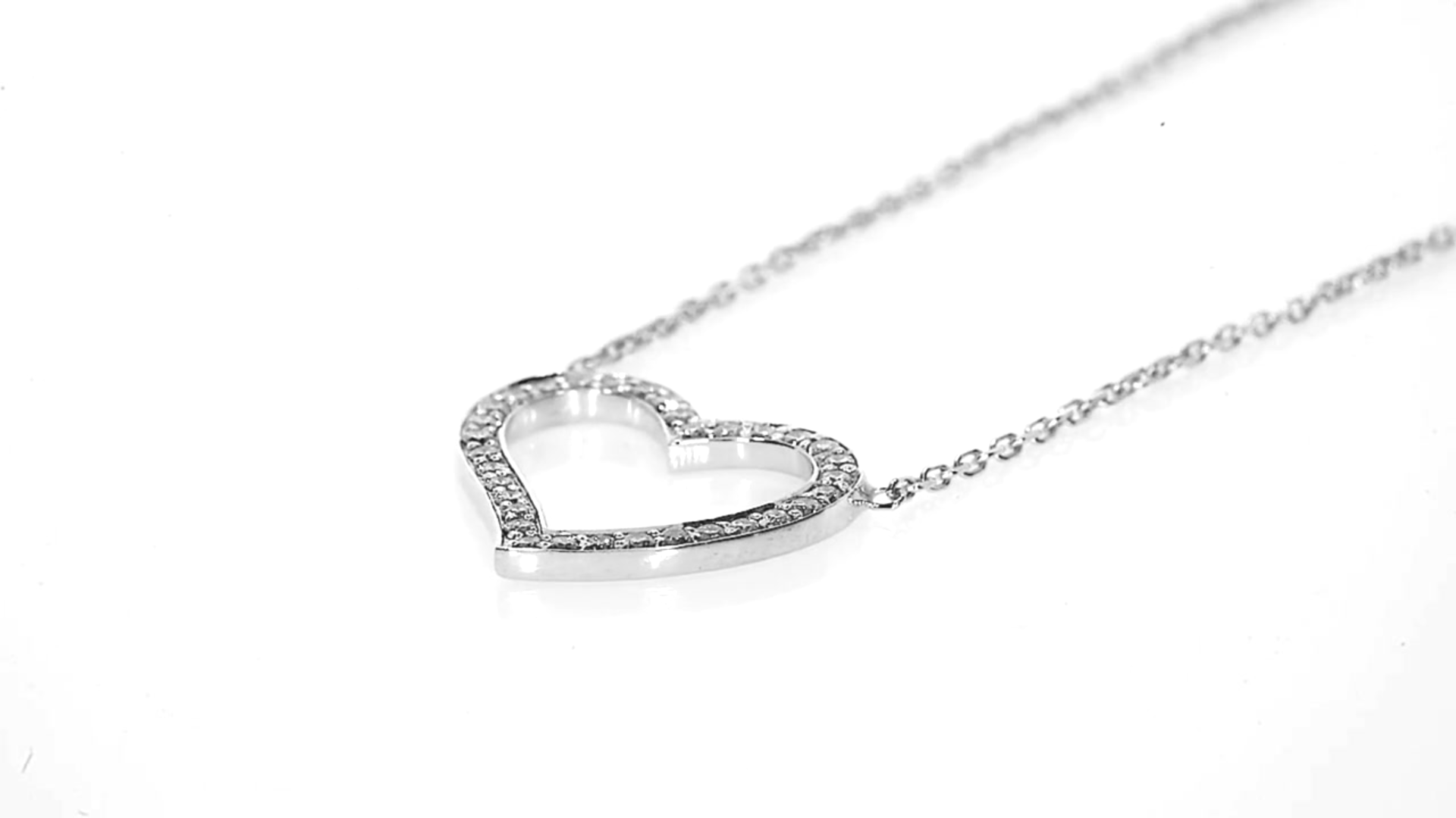 The Amélie Necklace featuring a heart pendant with round brilliant diamonds in 18ct gold, showcasing luxury and elegance.