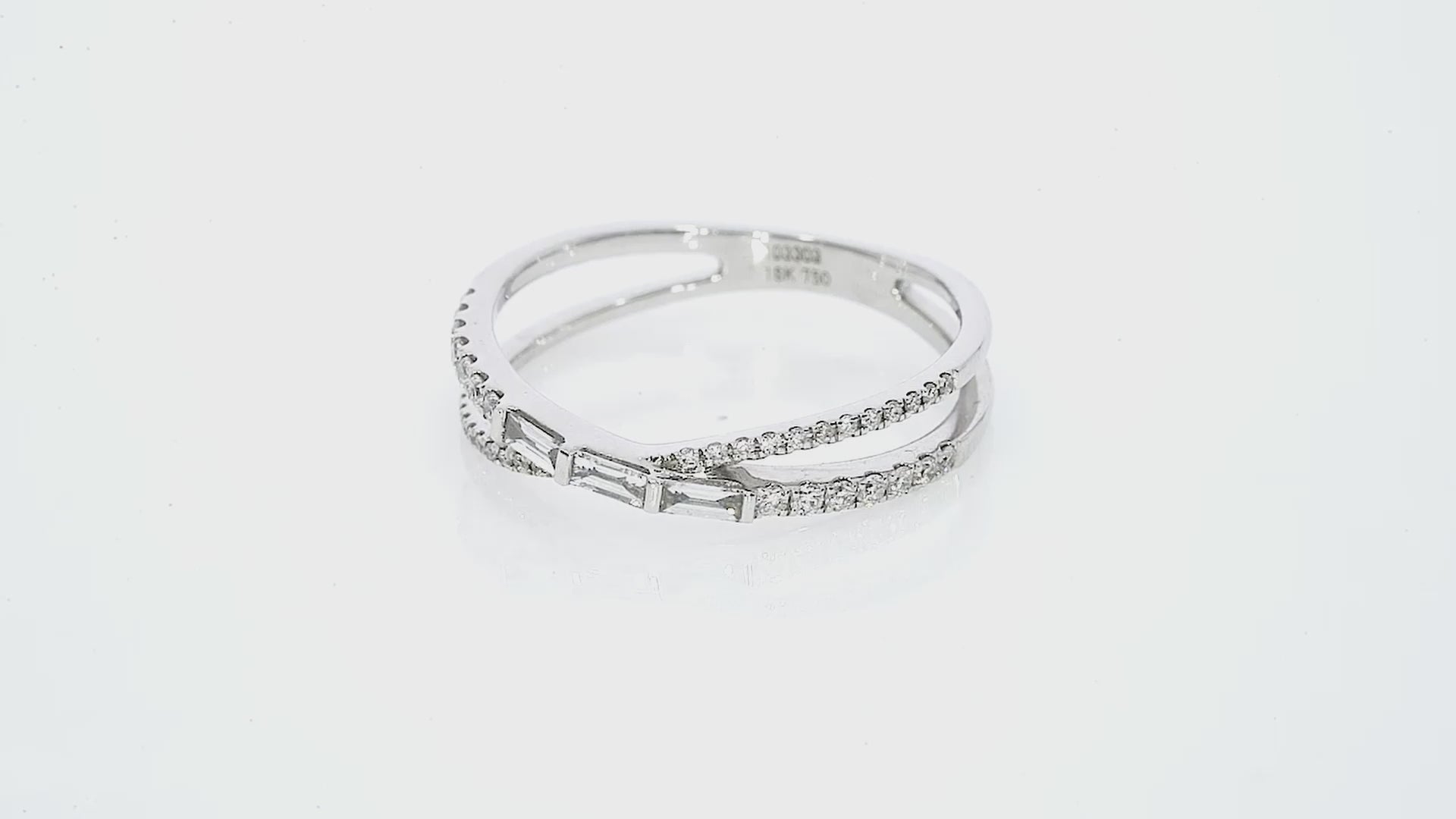 Baguette criss cross ring featuring diamond accents set in 18ct gold, showcasing elegance and modern design.