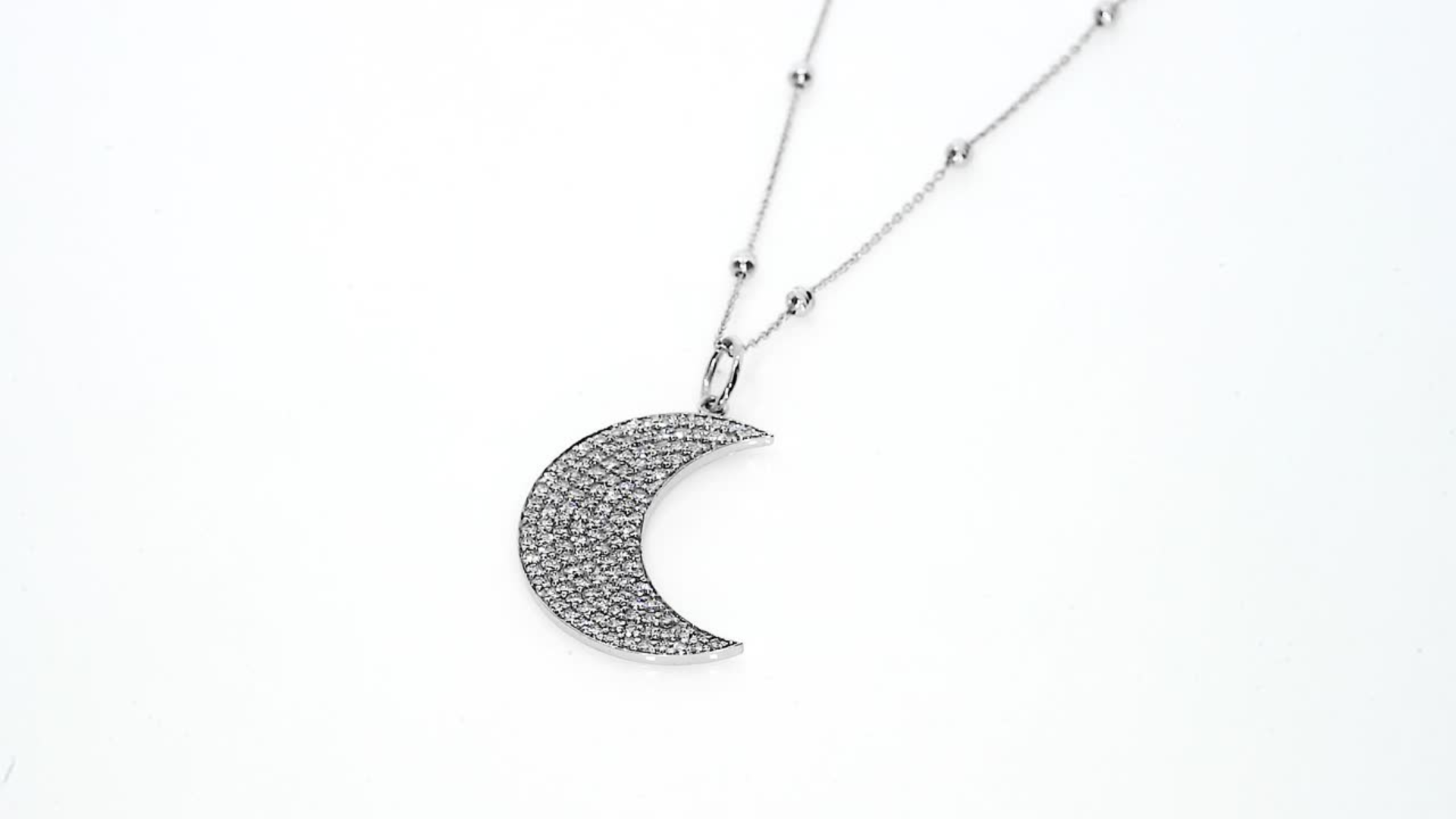Elegant diamond necklace featuring a crescent moon design on a fine chain, crafted in 18ct gold.