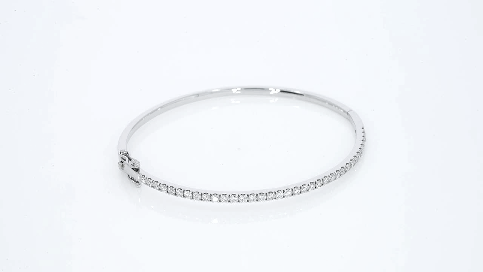 Diamond tennis bangle featuring diamonds set in white gold for a modern luxe look.